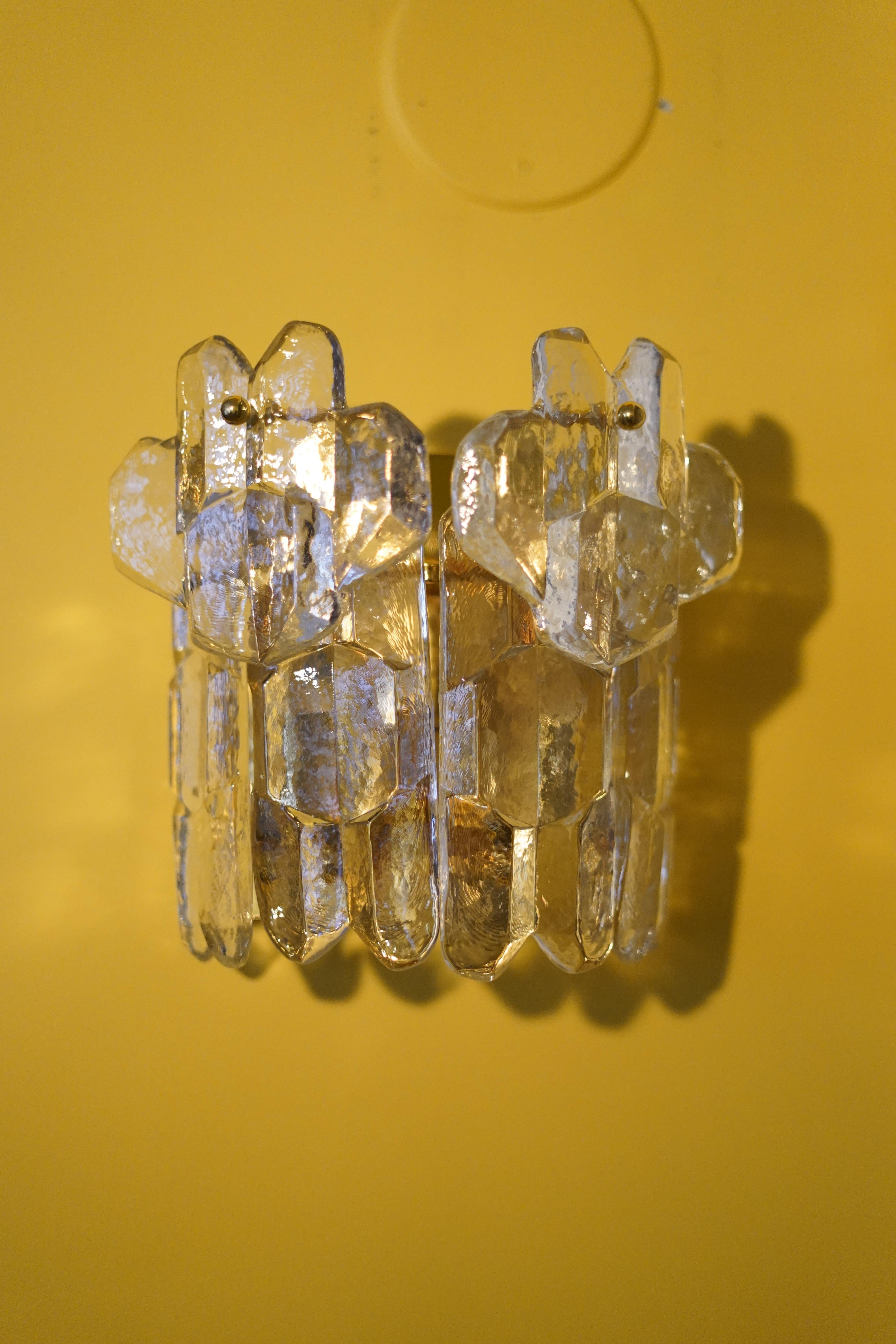 Pair Kalmar palazzo crystal sconces 1970s Vienna Austria, four thick clear elongated heavy pieces of highest quality press crystal mounted on a gilt frame with two single upper pieces mounted above the lower row of crystal glass all works as a shade