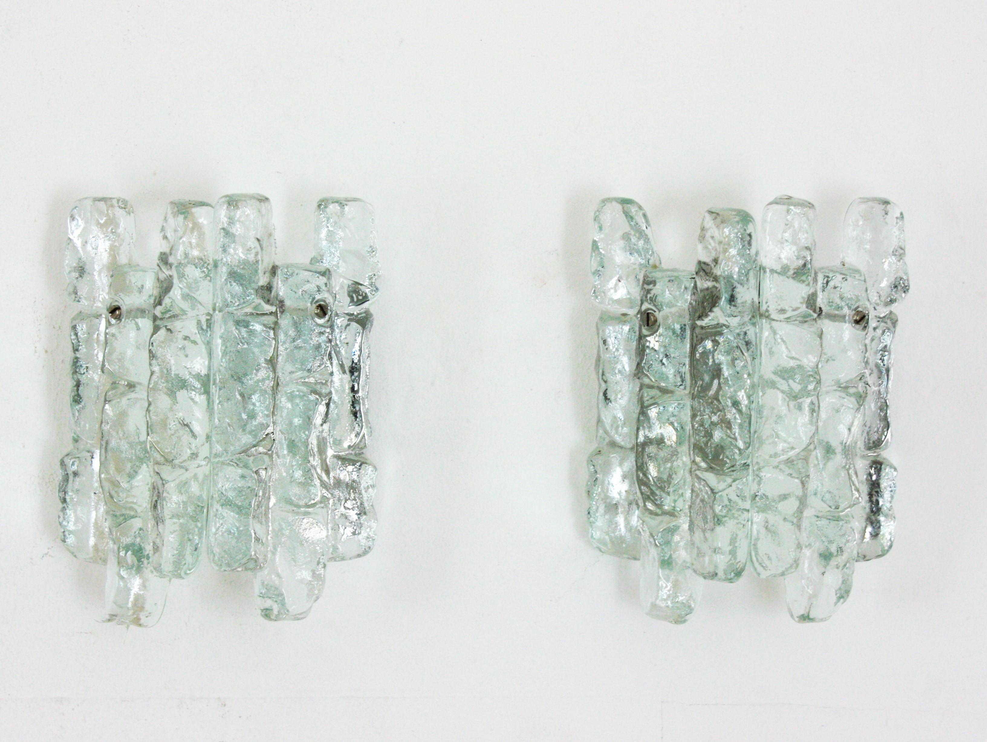 Pair of ice glass Kalmar wall sconces. Each one is composed by two pieces of ice glass blocks placed on a metal base.
This pair of sconces is in excellent condition and they have been new rewired,
Austria, 1960s.
Newly wired with 1 E14 bulb
