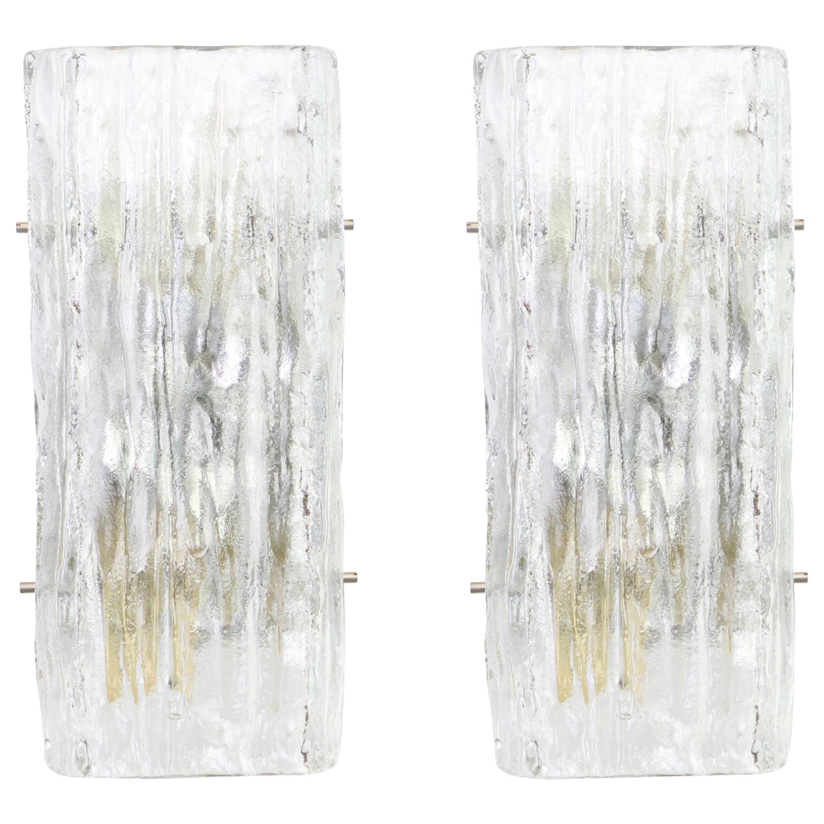 Wonderful pair of midcentury wall sconces with ice glass, made by Kalmar, Austria, manufactured, circa 1960-1969.
High quality and in very good condition. Cleaned, well-wired and ready to use.  

The fixture requires 2 x E14 Standard bulbs with