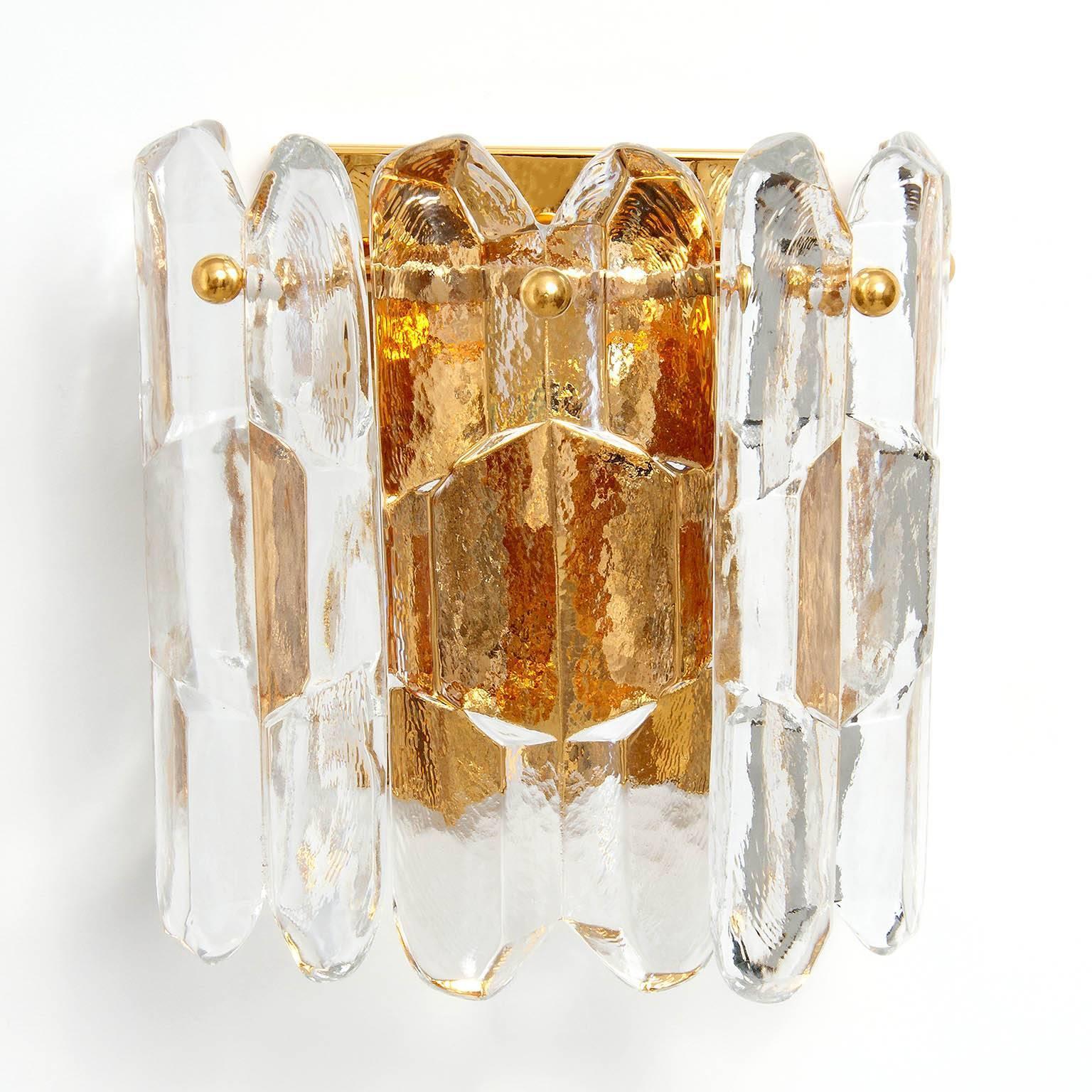 A pair of very exquisit 24-carat gold-plated brass and clear brillant glass 'Palazzo' wall lights by J.T. Kalmar, Vienna, Austria, manufactured in circa 1970 (late 1960s and early 1970s). 
The lamps are labeled on the backside of the