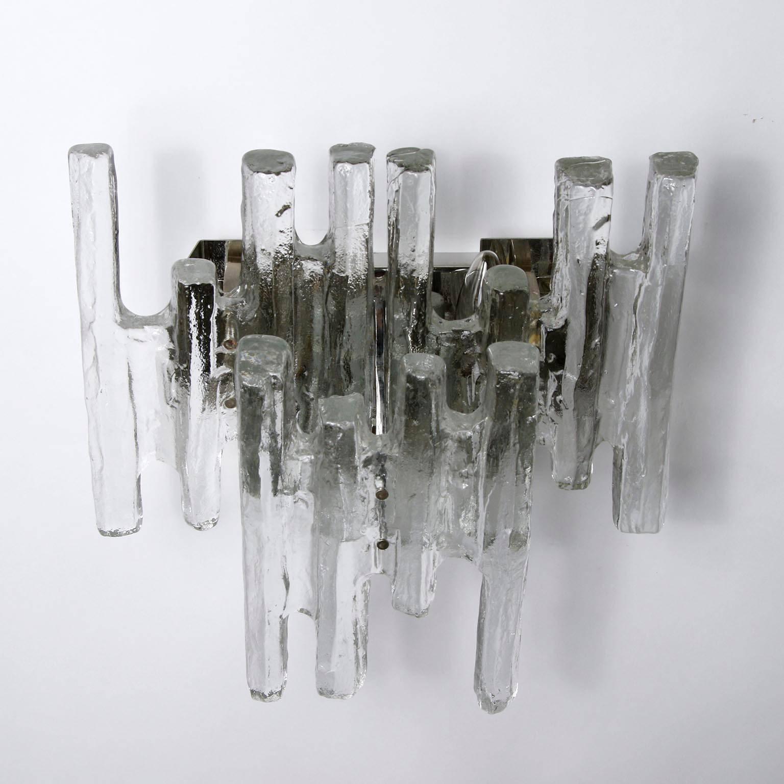 A pair of Mid-Century Modern icicle glass wall lights model 'PAN' (no. 4519) by J.T. Kalmar, Austria, manufactured circa 1970 (late 1960s or early 1970s).
There are three pairs available. The price is per pair.
Each light fixture is made of three