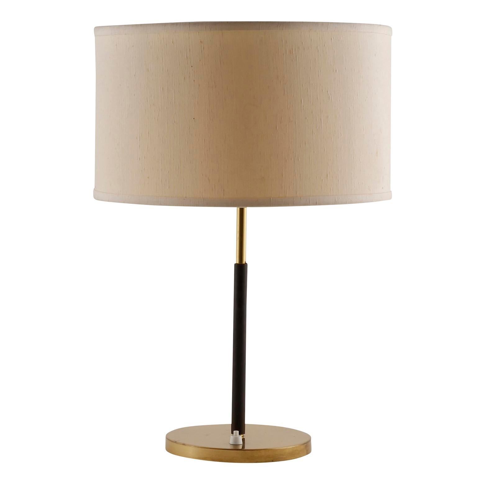 A pair of table lamps by J.T. Kalmar, manufactured in midcentury, circa 1960.
They are made of a brass covered base, a covered Stand with dark brown leather, brass fittings, and a cream colored lampshade.
Each lamp takes two medium or standard