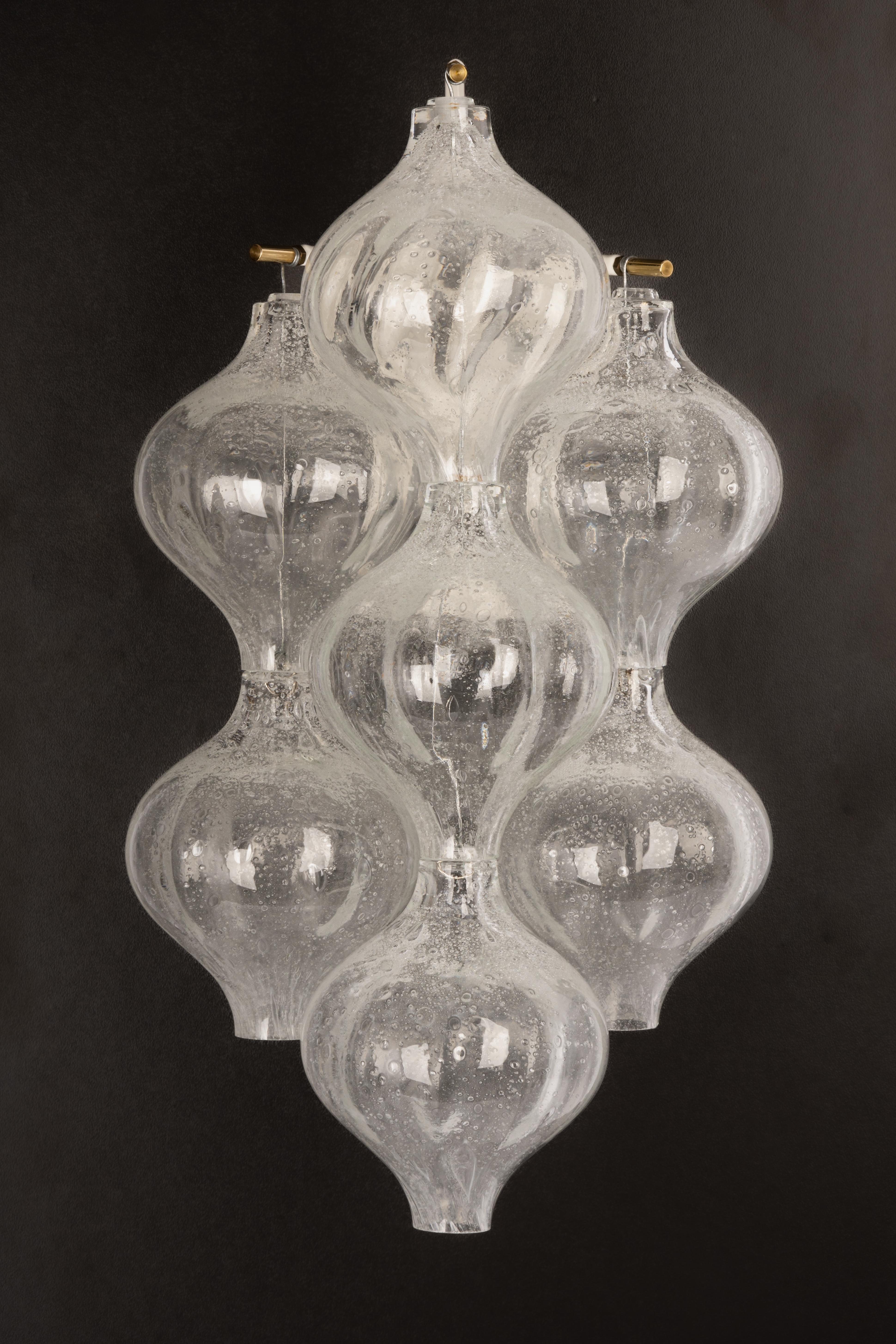 Wonderful pair of mid-century wall sconces, made by Kalmar, Austria, manufactured, circa 1970-1979.
Each tulip-shaped glass is handmade which makes each glass piece is a unique piece. Each sconce is made of 7 glass pieces on a white enameled metal