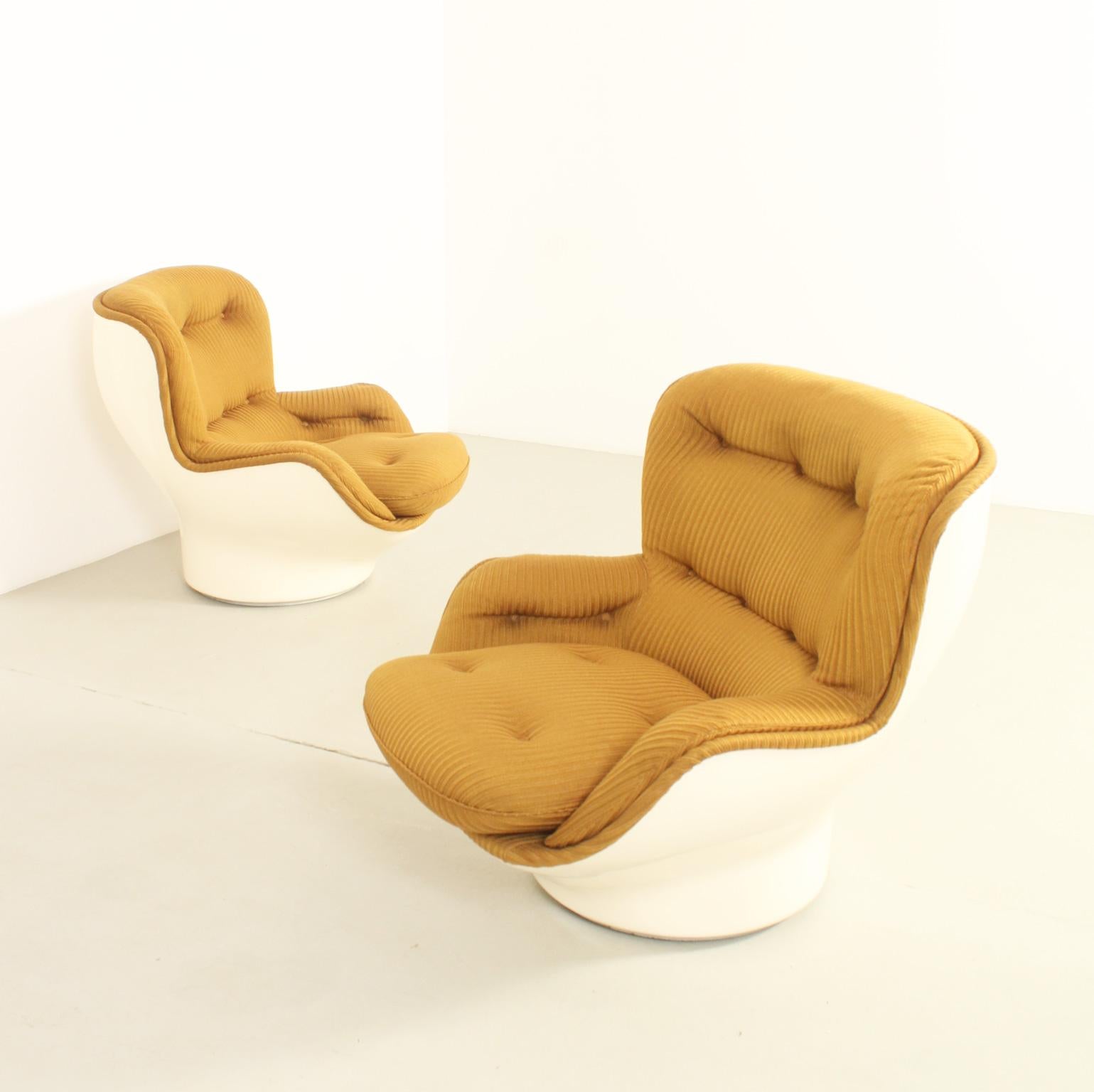 Pair of Karate armchairs designed in 1970's by Michel Cadestin for Airborne, France. Molded fiberglass shell upholstered with original fabric and loose seat cushion. Swivel base. 