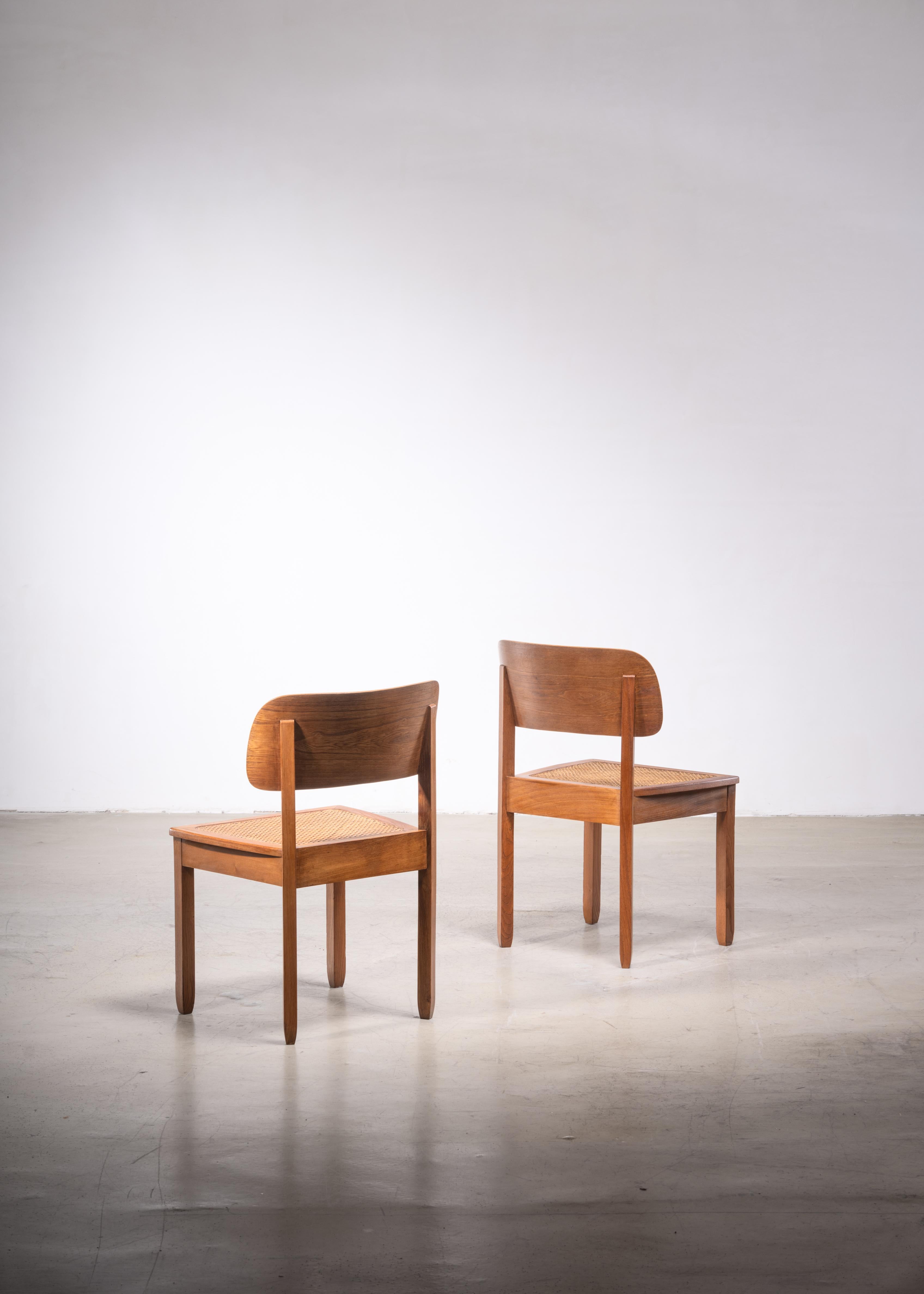 A pair of 1930s chairs by German designer Karl Bertsch (1873-1933) for the Deutsche Werkstätten Hellerau, Dresden. These very light chairs are made of wood with a curved backrest and a woven cane seating. Wonderful original condition.