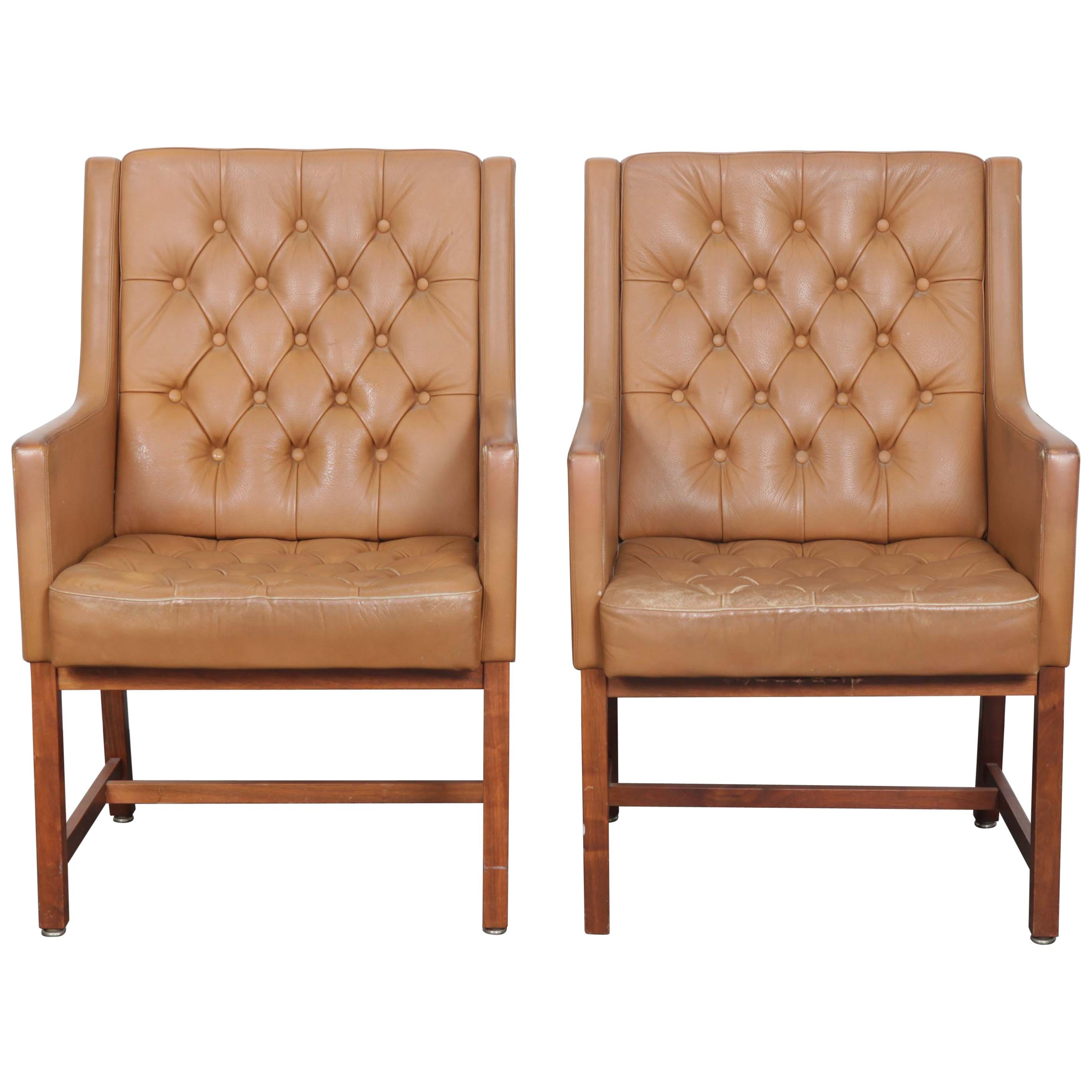 Great example of a pair of brown tufted leather chairs with solid teak legs, designed by Karl Erik Ekselius for JOC Mobler, Sweden. Leather is in very good condition with no tears or damage, and shows a minor amount of nice patina.