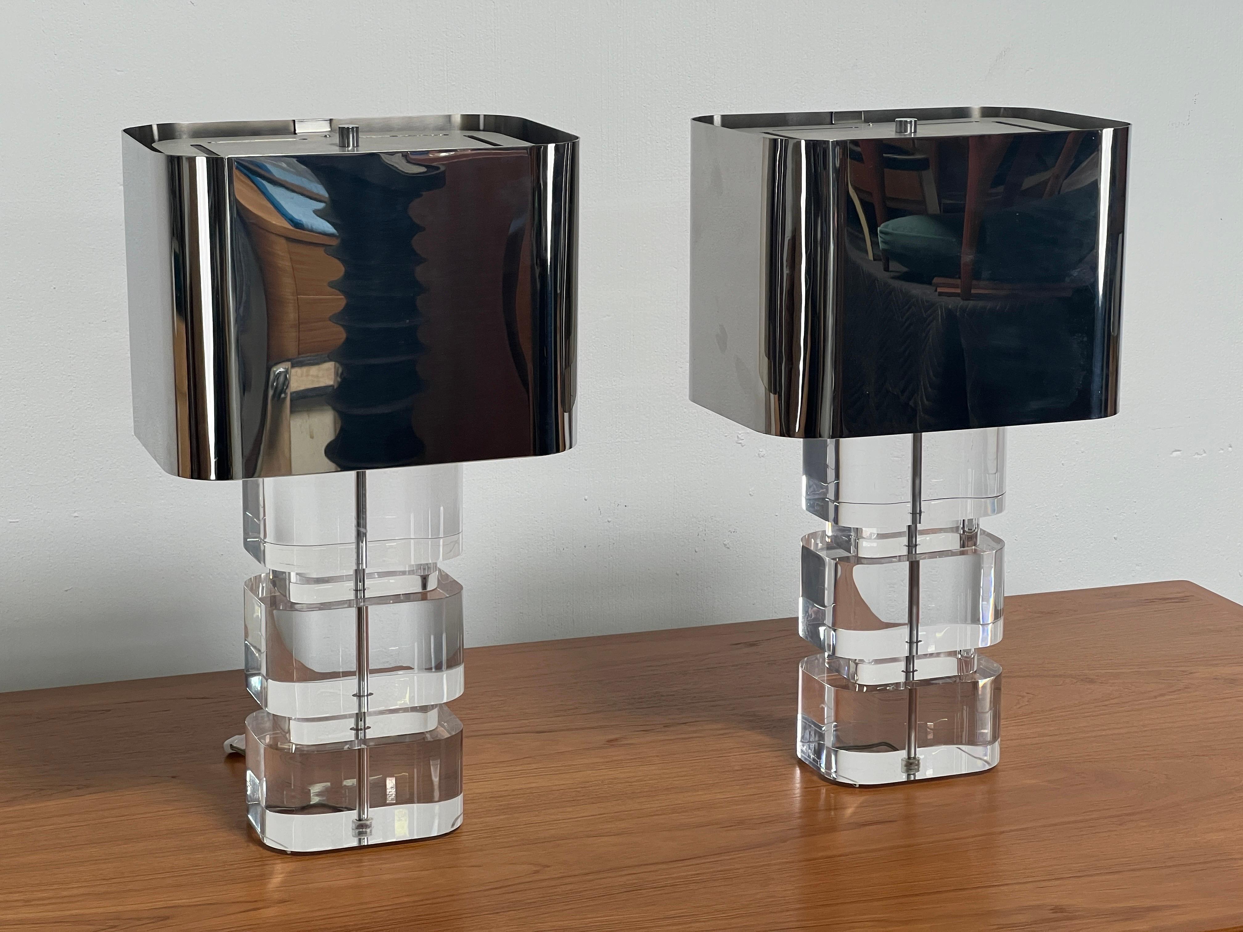 A pair of signed Karl Springer acrylic table lamps with original polished stainless steel shades. 