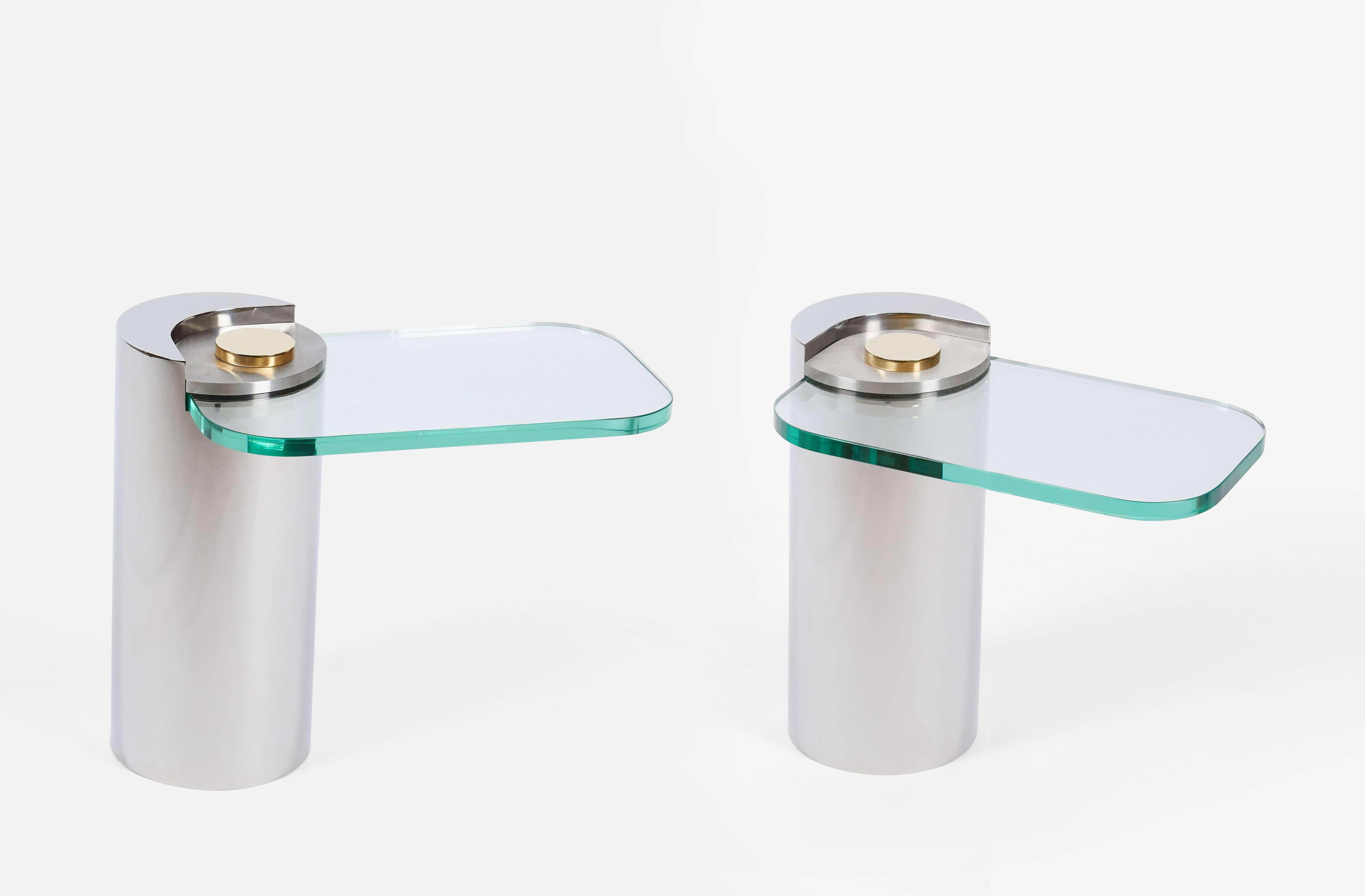 Pair of sculpture leg side tables by Karl Springer. Mixed metal bases with polished stainless steel bases, brushed stainless top plate, and polished brass finial that holds cantilevered glass in place. New glass, free of scratches.  Price is for
