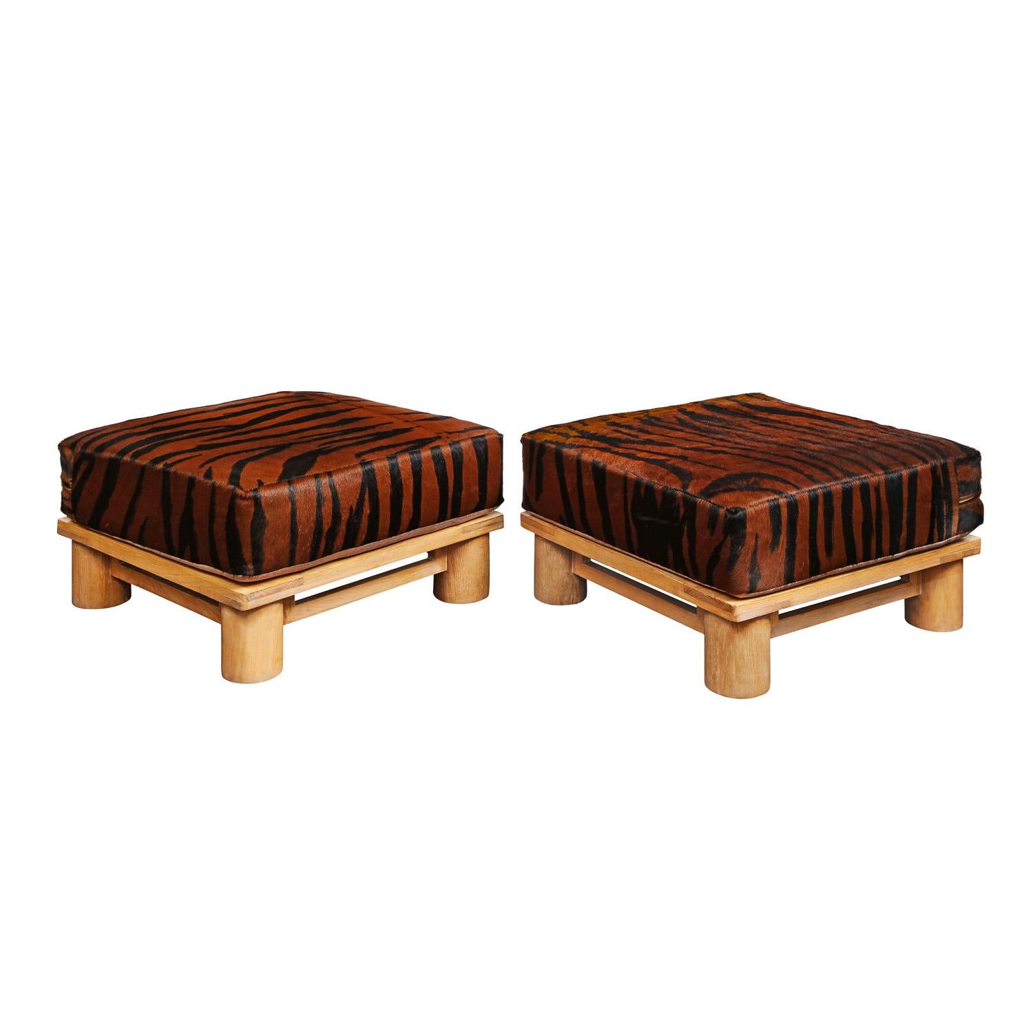 Pair of “Dowelwood Ottomans” with cushions upholstered in brown zebra printed pony skin by Karl Springer, American 1980's. These ottomans, like all of Springer’s pieces, are beautifully crafted.

Reference:
Karl Springer LTD Red Binder Catalog