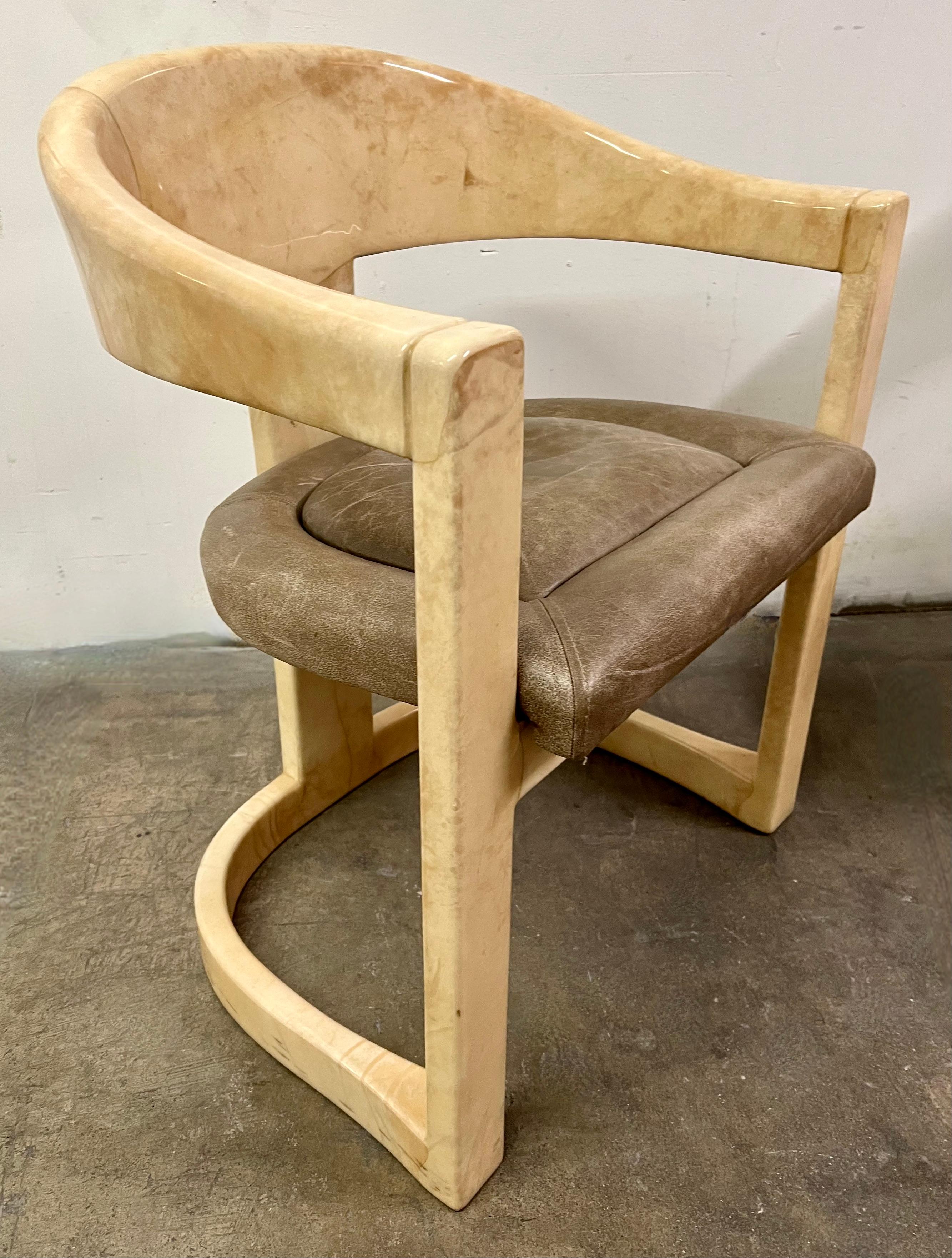 A pair of original Karl Springer Onassis chairs in lacquered goatskin. The pair have been in a one user household and are in great vintage condition. We have six of the same chair in this finish and upholstery... will sell as a pair or all six, and