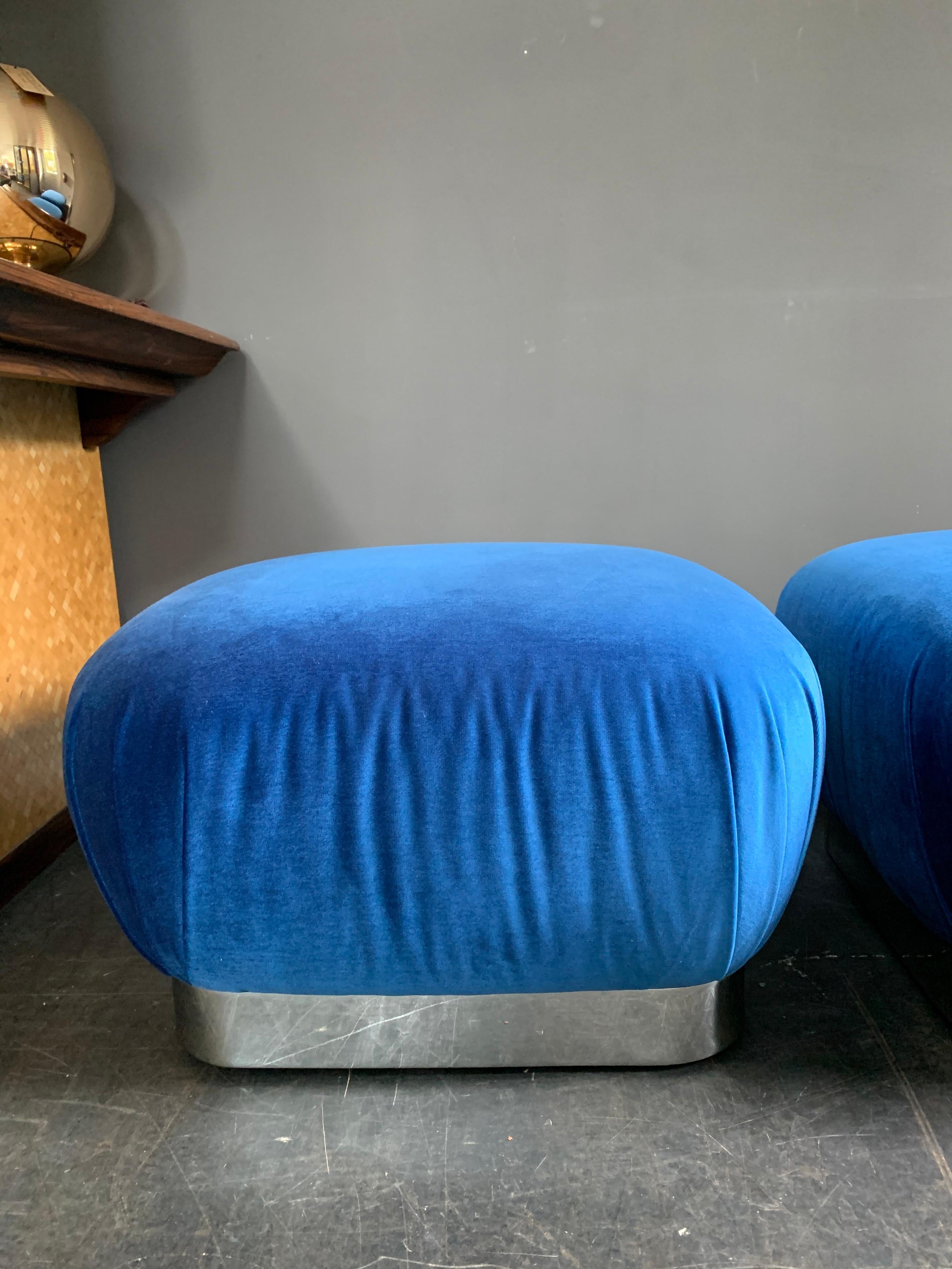 Original pair of Karl Springer Souffle ottomans/poufs on casters for easy moving. Polished steel base and blue velvet upholstery.