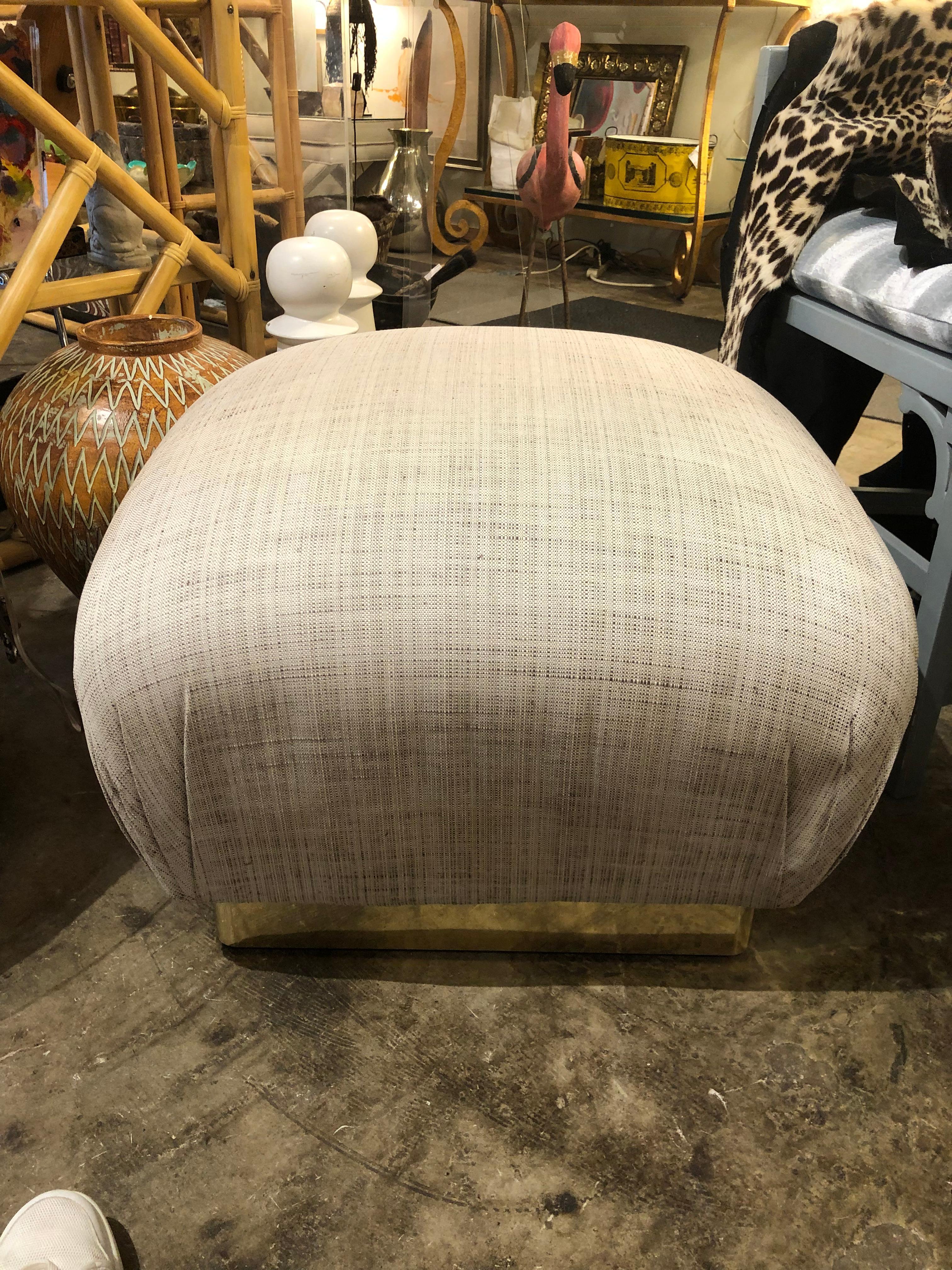 Pair of Karl Springer souffle pouf ottomans with brass plinths all upon hidden casters.