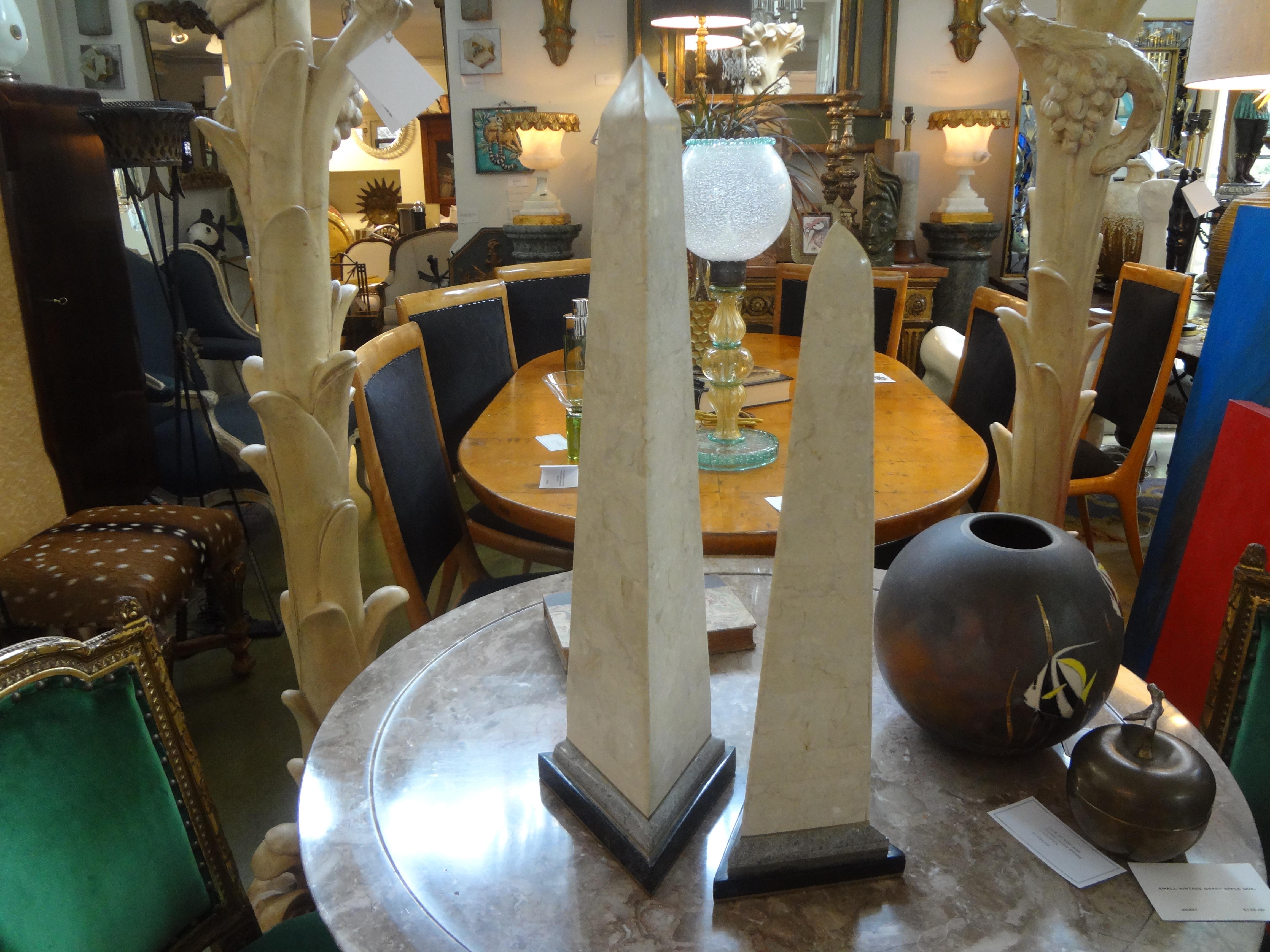 Great pair of vintage Karl Springer inspired tessellated stone obelisks with brass trim. These Hollywood Regency tessellated stone and brass obelisks consist of two matching pieces. The taller one is 24.5