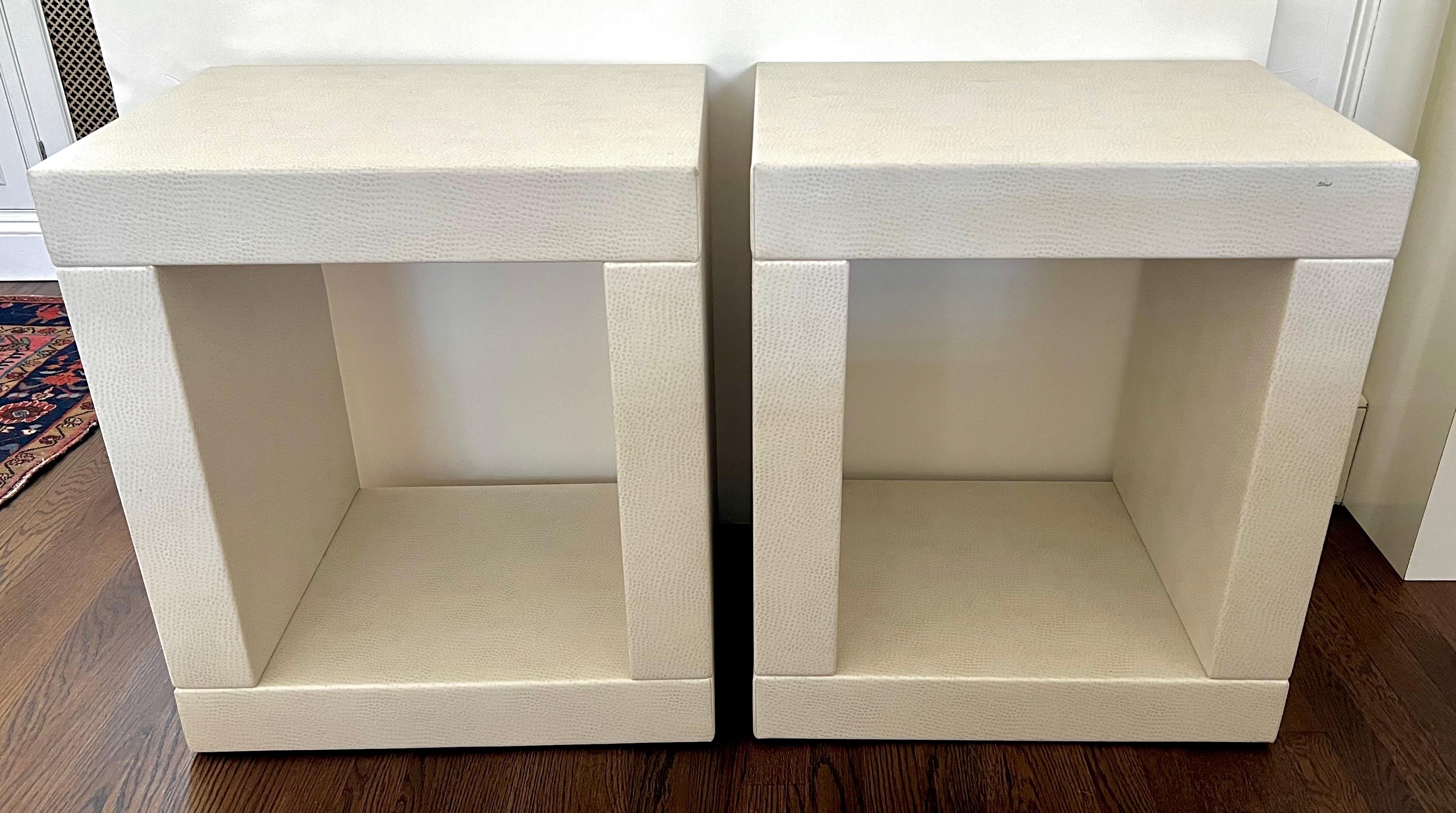 Unique contemporary Karl Springer style end tables or nightstands upholstered in a white faux snakeskin.