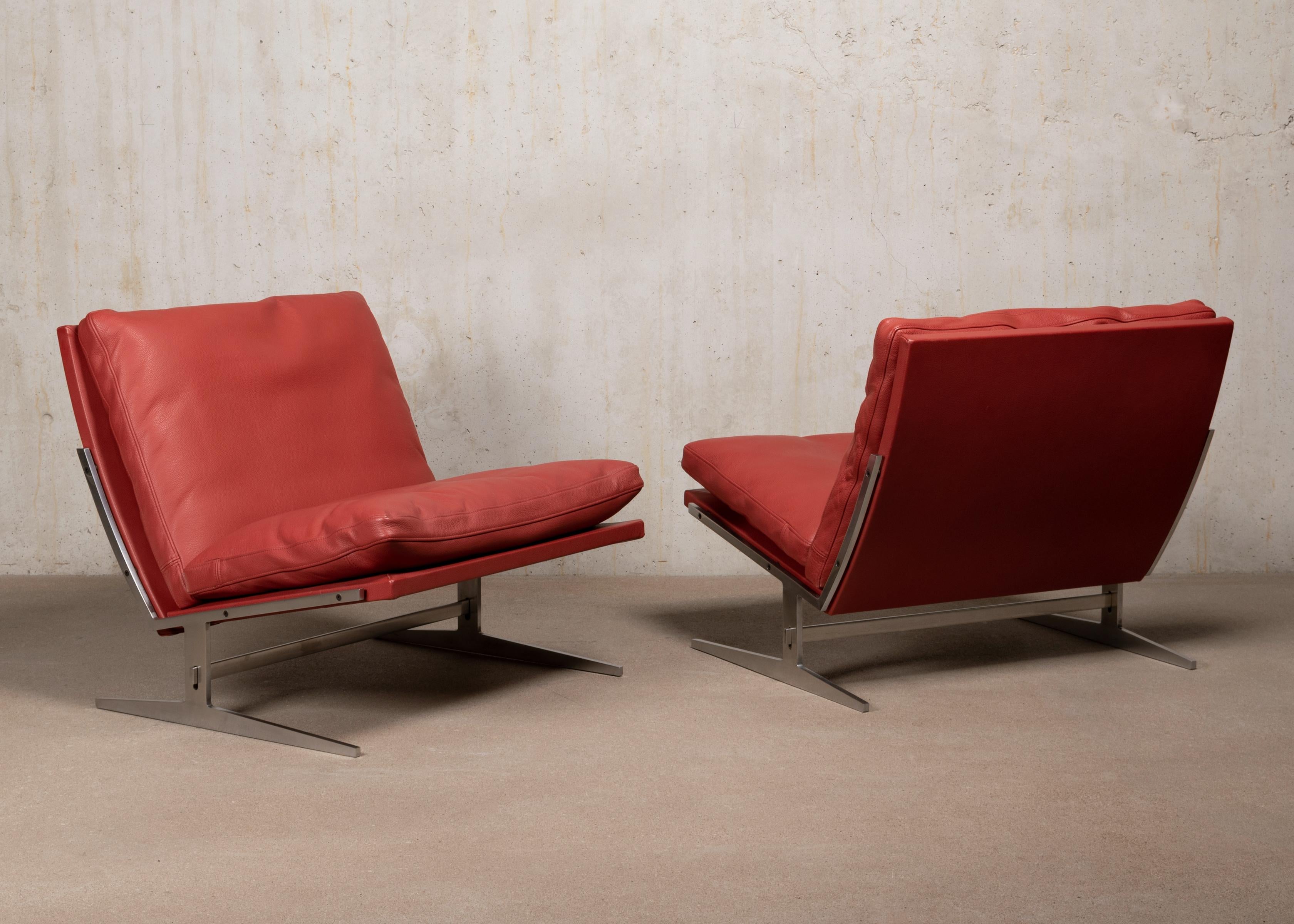 Beautiful pair slipper lounge chairs by Jørgen Kastholm & Preben Fabricius model Bo-561 produced by Bo-Ex in Denmark. Polished steel frame and recent Ruby Red leather upholstery with down feathers filled cushions all in very good condition with only