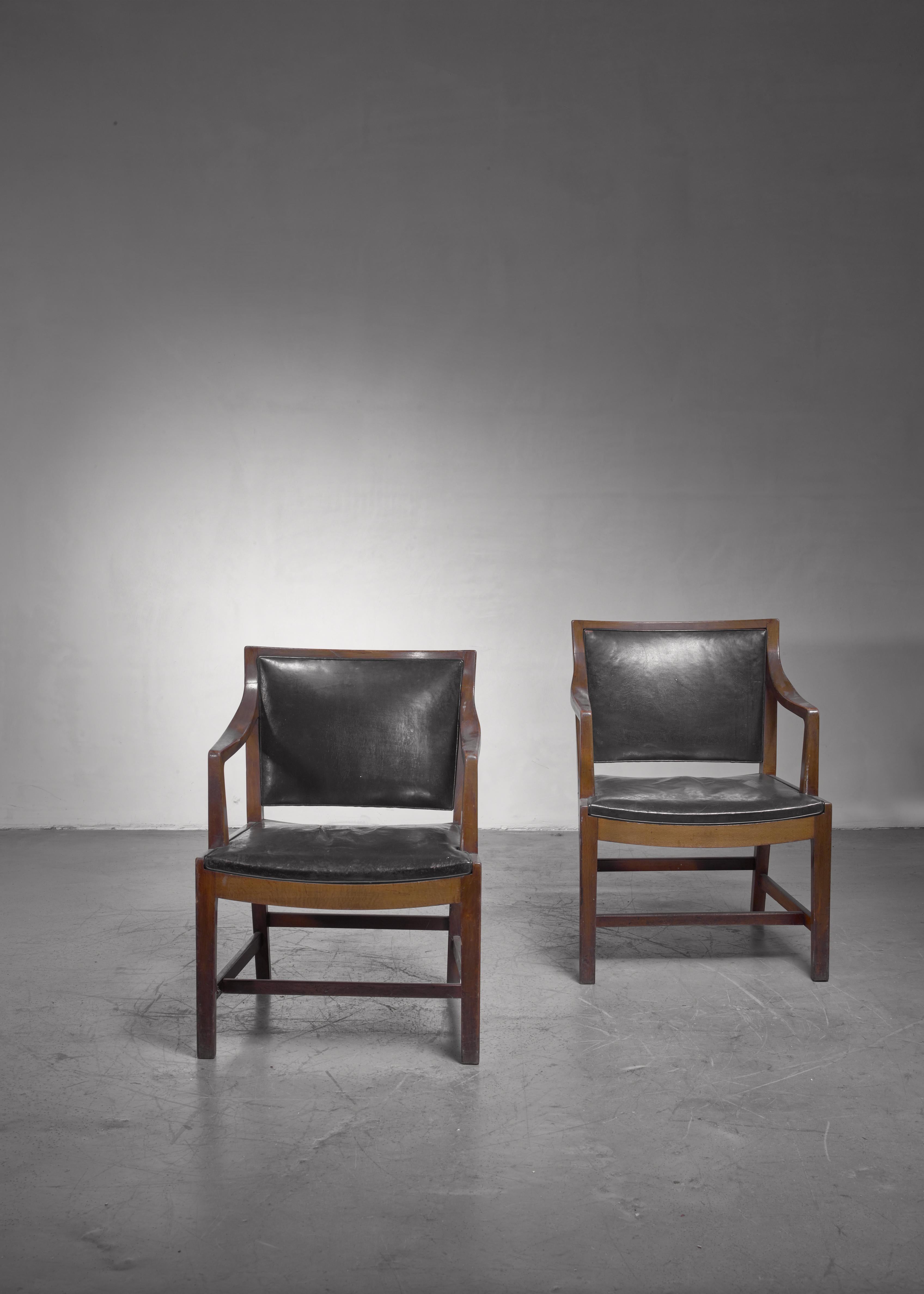 A rare pair of armchairs made of stained beech, upholstered with a dark green leather. These chairs were designed for and used on the Kronprins Frederik ferry (built 1941), which was furnished by Fisker. The model was later also used on the Kong