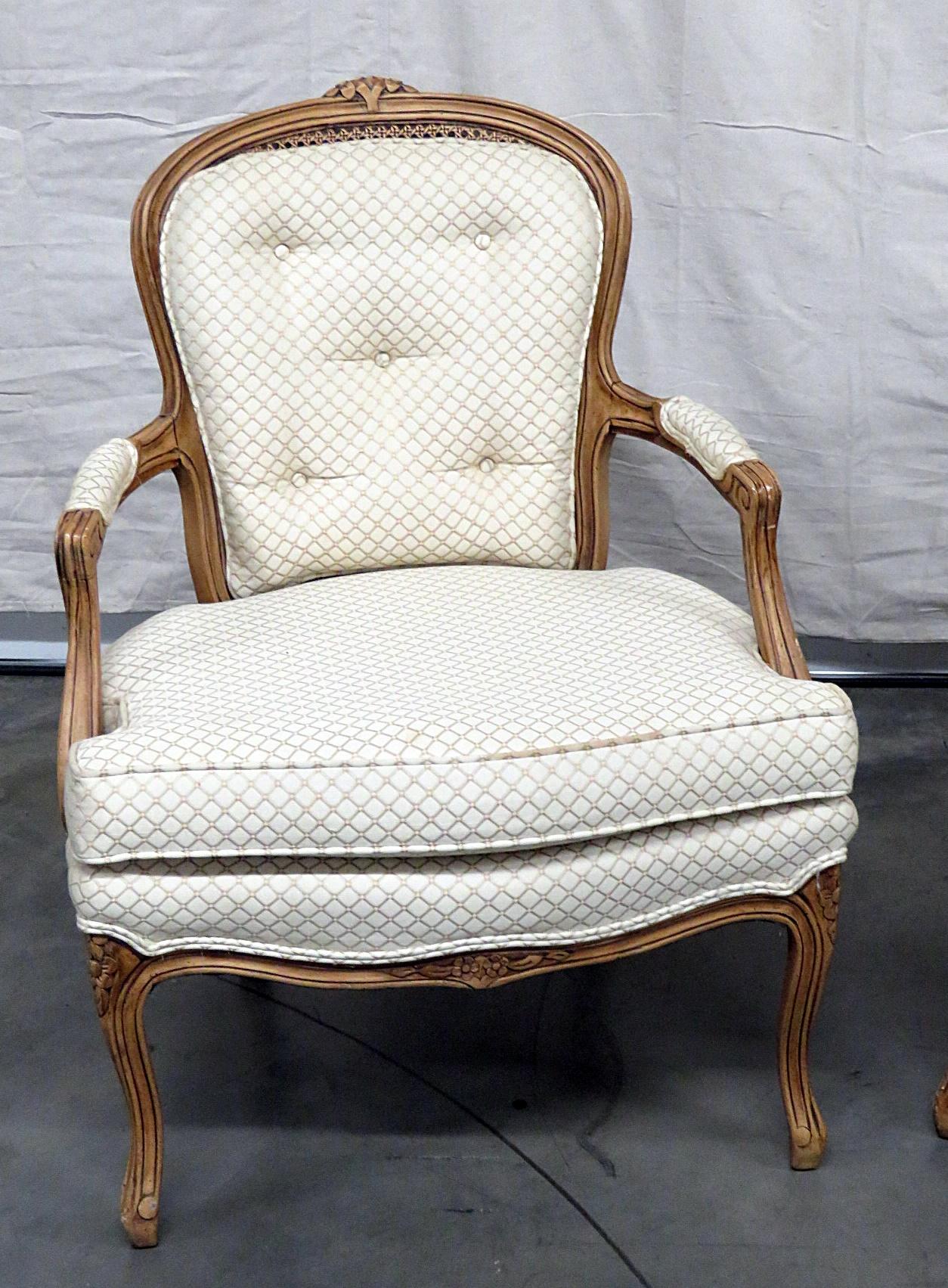 Pair of Kaylyn Louis XVI style armchairs with a distressed finish and caned backs.