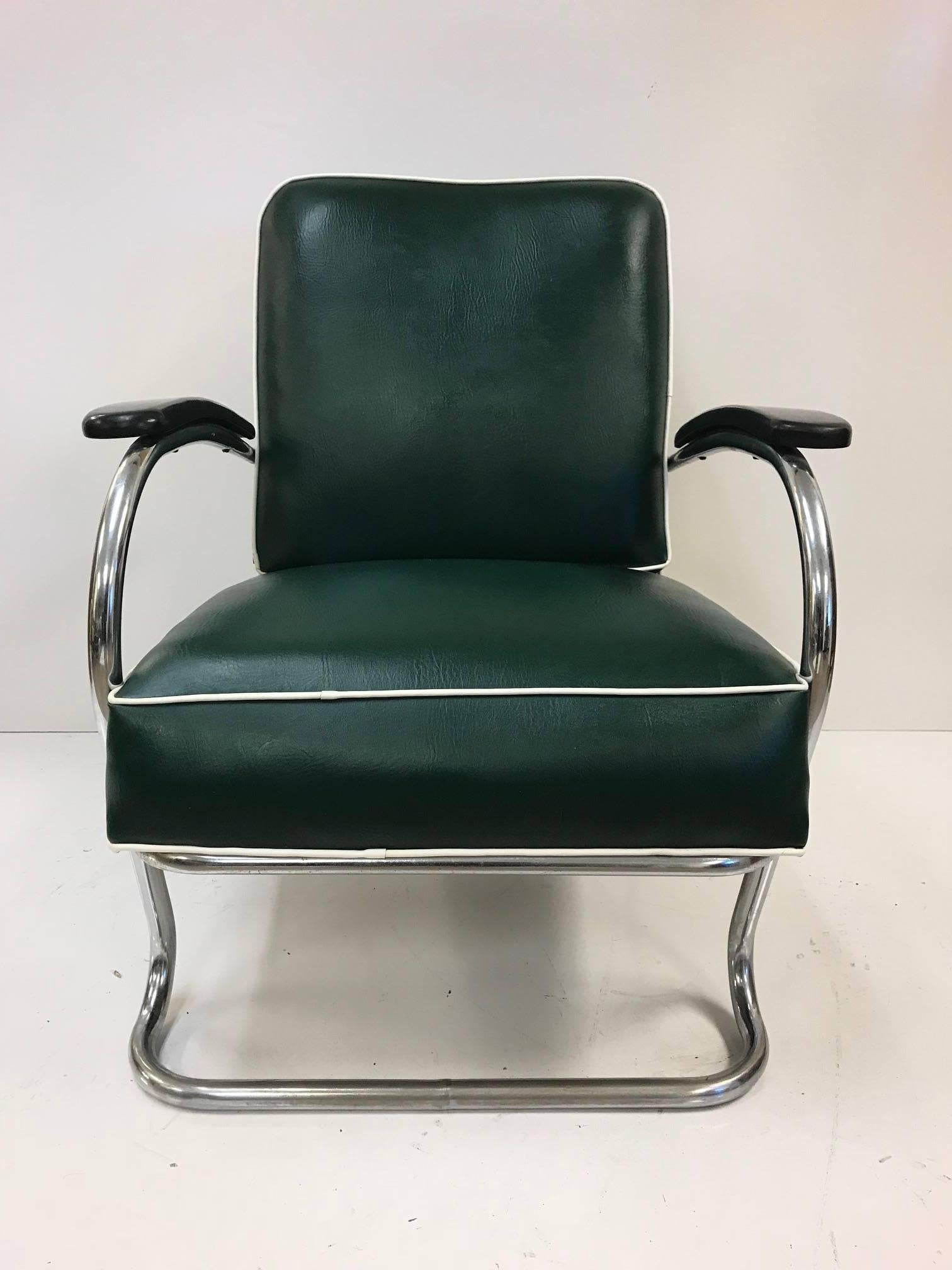 Pair of KEM Weber for Lloyd Tubular chrome lounge chairs. Chairs are vinyl with a steel frame. Chairs have original fabric and are of a hunter green color with white trim.
 
   