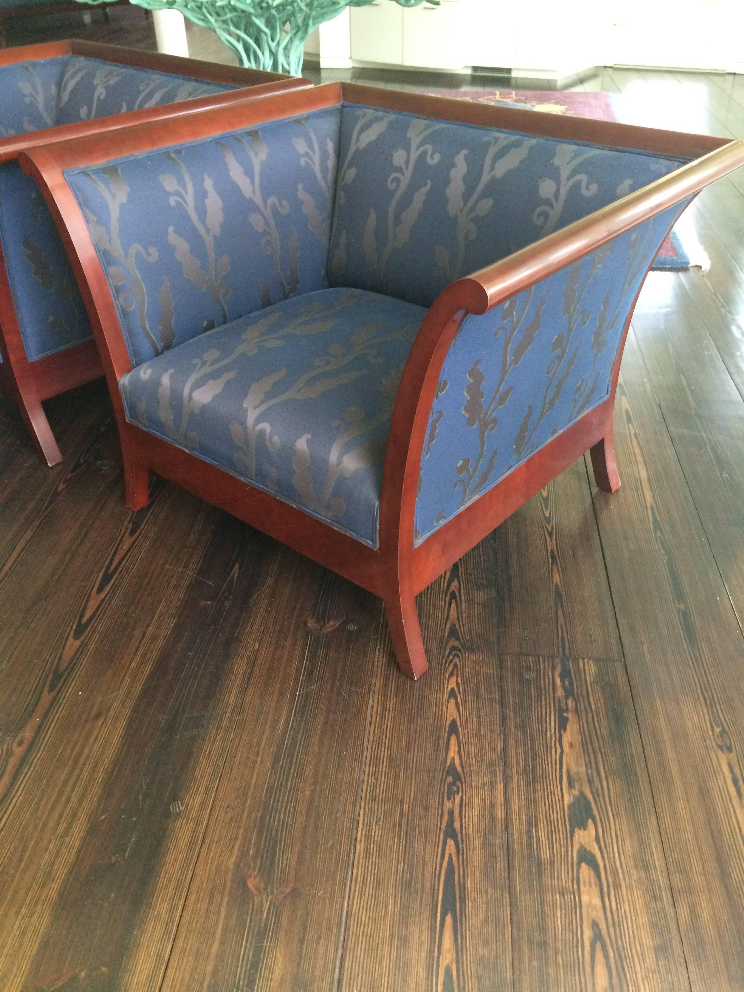 A pair of impressive mahogany Art Deco style club chairs, large, box shaped, with angular splayed arms and feet, upholstered in striking dark purple blue fabric for a firm comfy seat. By high end NYC furniture purveyor, Kenneth Winslow, from 20