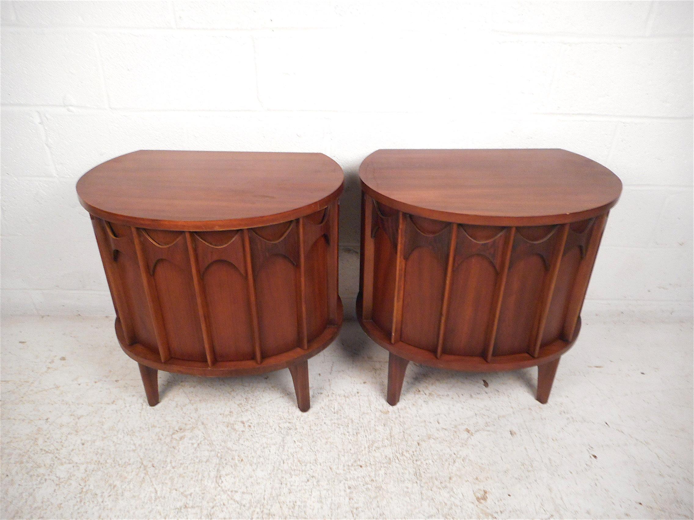 Beautiful pair of highly sought-after midcentury end tables by Kent Coffey. Sculpted wooden accents on the door-fronts which are emblematic of the 