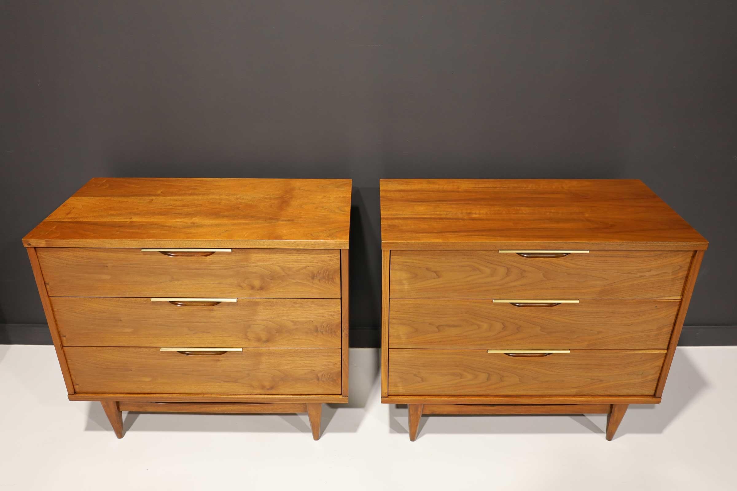 Newly restored walnut nightstands by Kent Coffey. Brass trim on recessed handles.