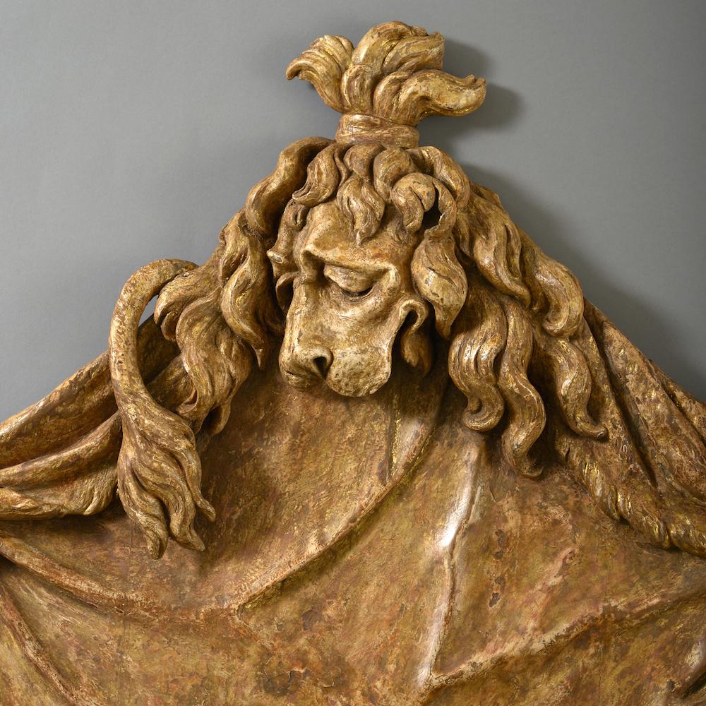 A pair of George II carved giltwood lion’s pelt overdoors, in the manner of William Kent, circa 1740.

Provenance:
The Dukes of Westminster,
Sold Christie’s, “Two Ducal Collections”, Woburn Abbey, 20-21st September 2004, lot 1138.