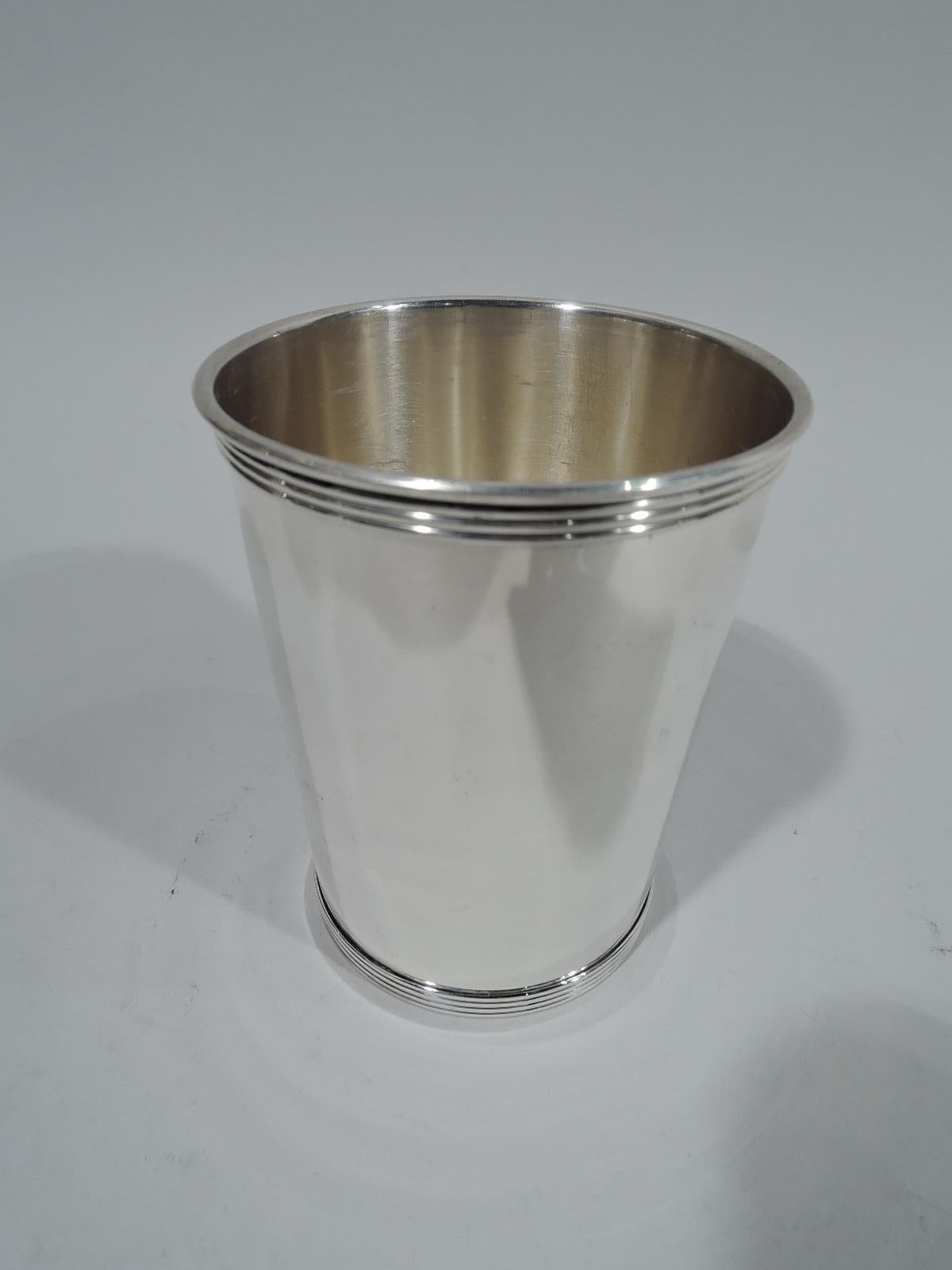 Pair of sterling silver mint julep cup. Straight and tapering sides, and reeded rim and foot. Fully marked including retailer’s stamp for AJ Winters Co., which was located in Paris, Kentucky. Weight: 7.5 troy ounces.
