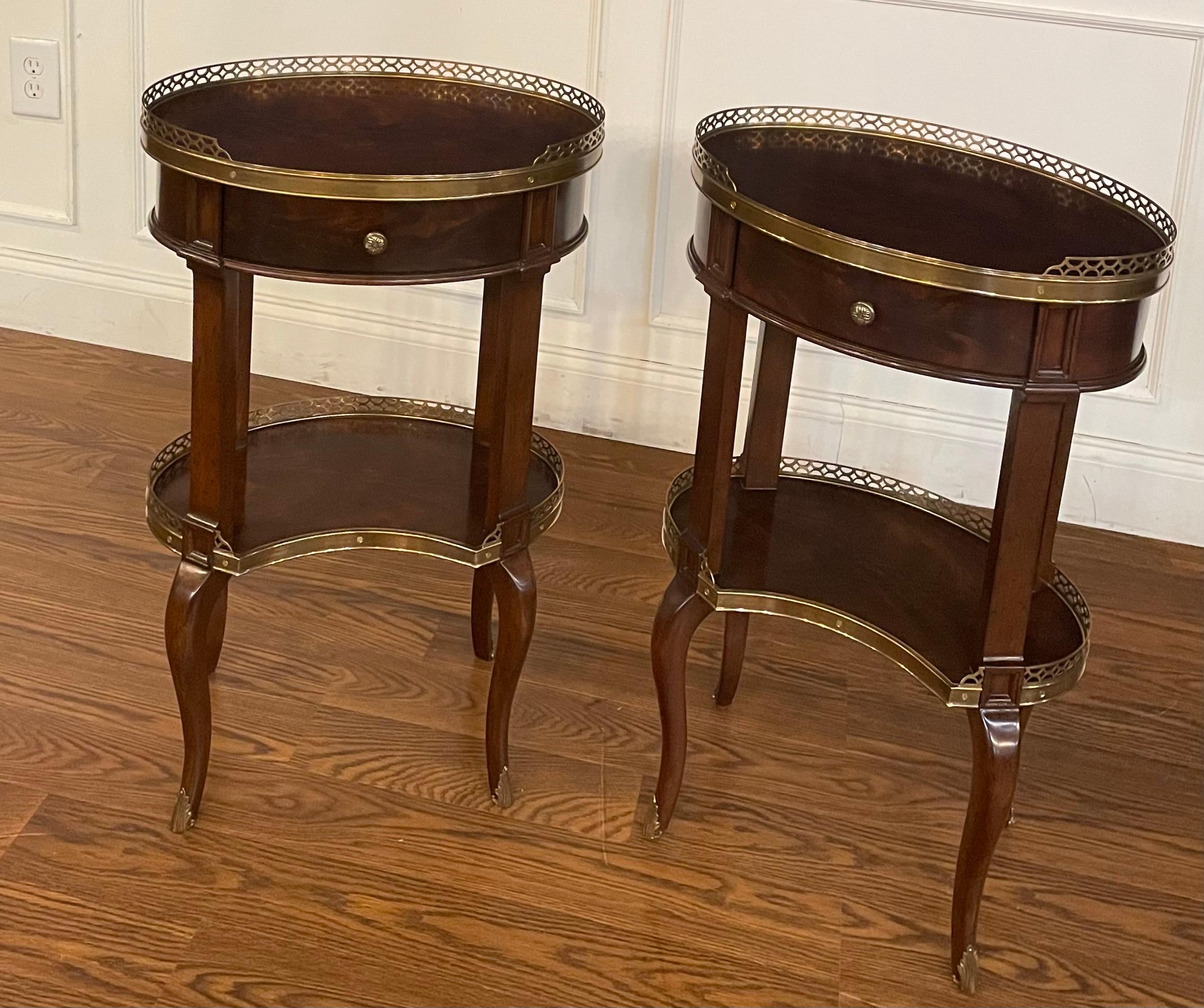 This is a pair (set of 2) Kidney shaped mahogany lamp/occasional tables by Leighton Hall.  They feature brass galleries and dovetailed drawers with solid brass pulls.  They have been used for less than one year as showroom samples and are in very