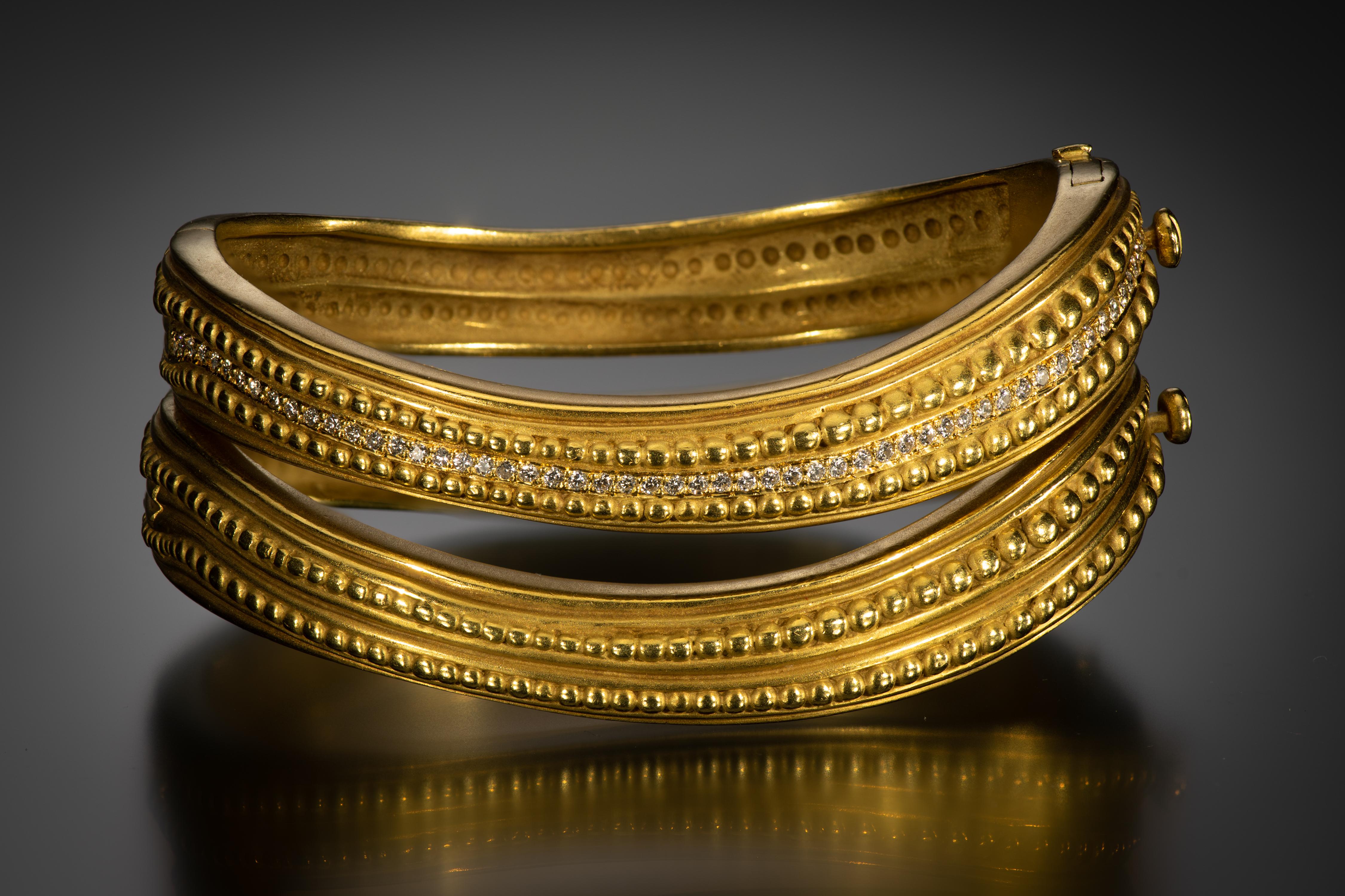 These vintage “caviar” bangles from famed jewelry Barry Kieselstein-Cord are made of solid, hammered 18k gold. They have an elegant sculptural shape with grooved and beaded textures, one featuring diamond accents. Wear on each arm or stack them for