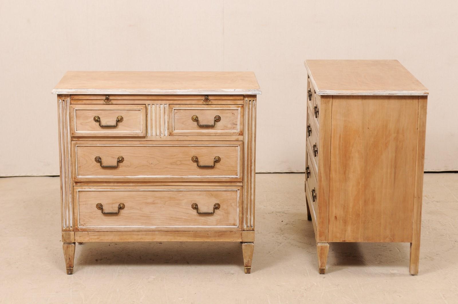A pair of vintage chests from American luxury furniture manufacturer Kindel (Grand Rapids, MI). This pair of Kindel chests each feature two half-sized drawers atop two full-sized, graduated bottom drawers. The front posts, as well as upper centre