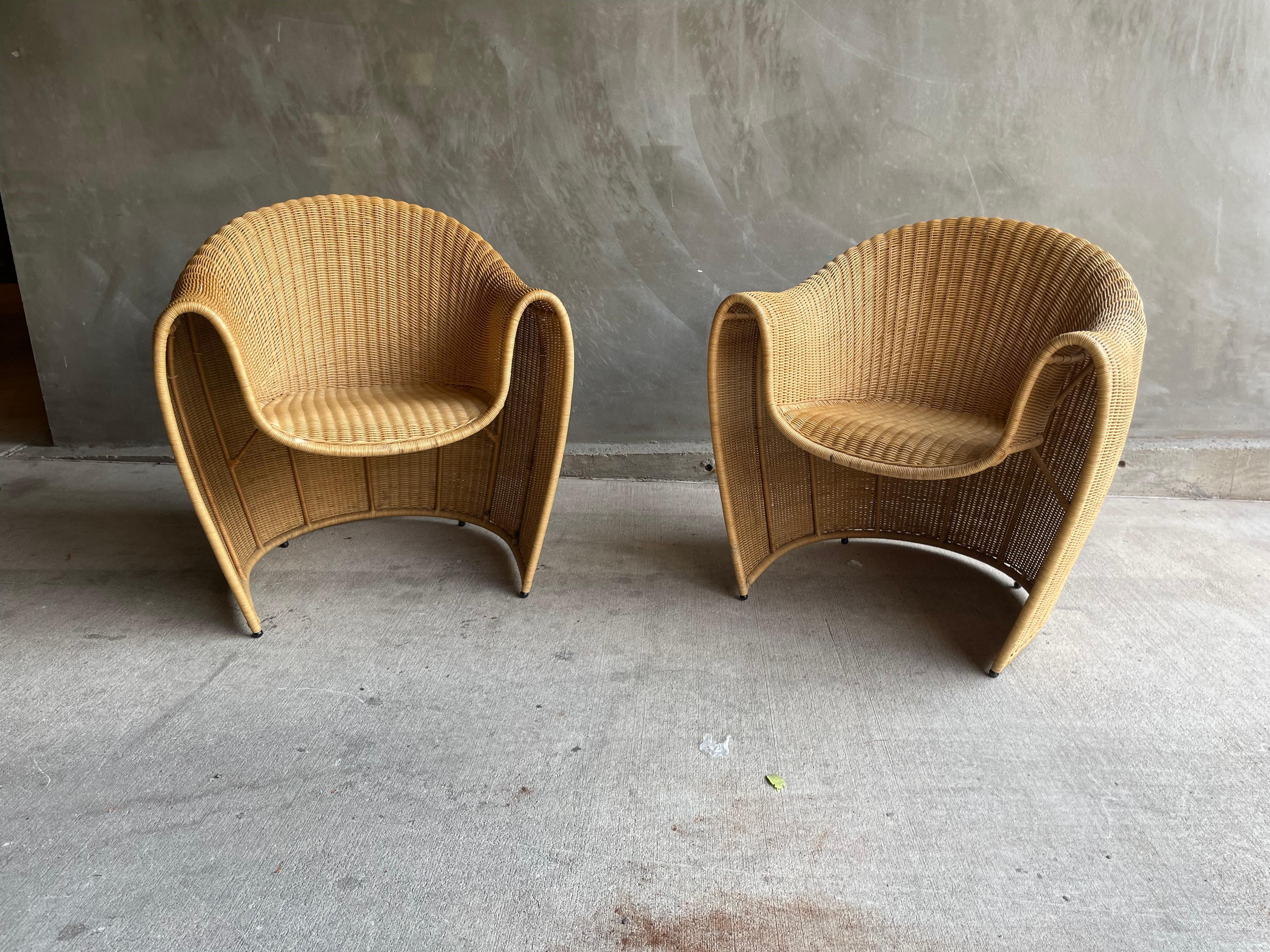 Pair of comfortable and sculptural King Tubby rattan armchairs designed by Miki Astoria for Driade.  Astoria preferred natural fibers like rattan, wood and iron which he combined to execute his finely designed pieces.  Woven rattan over heavy steel