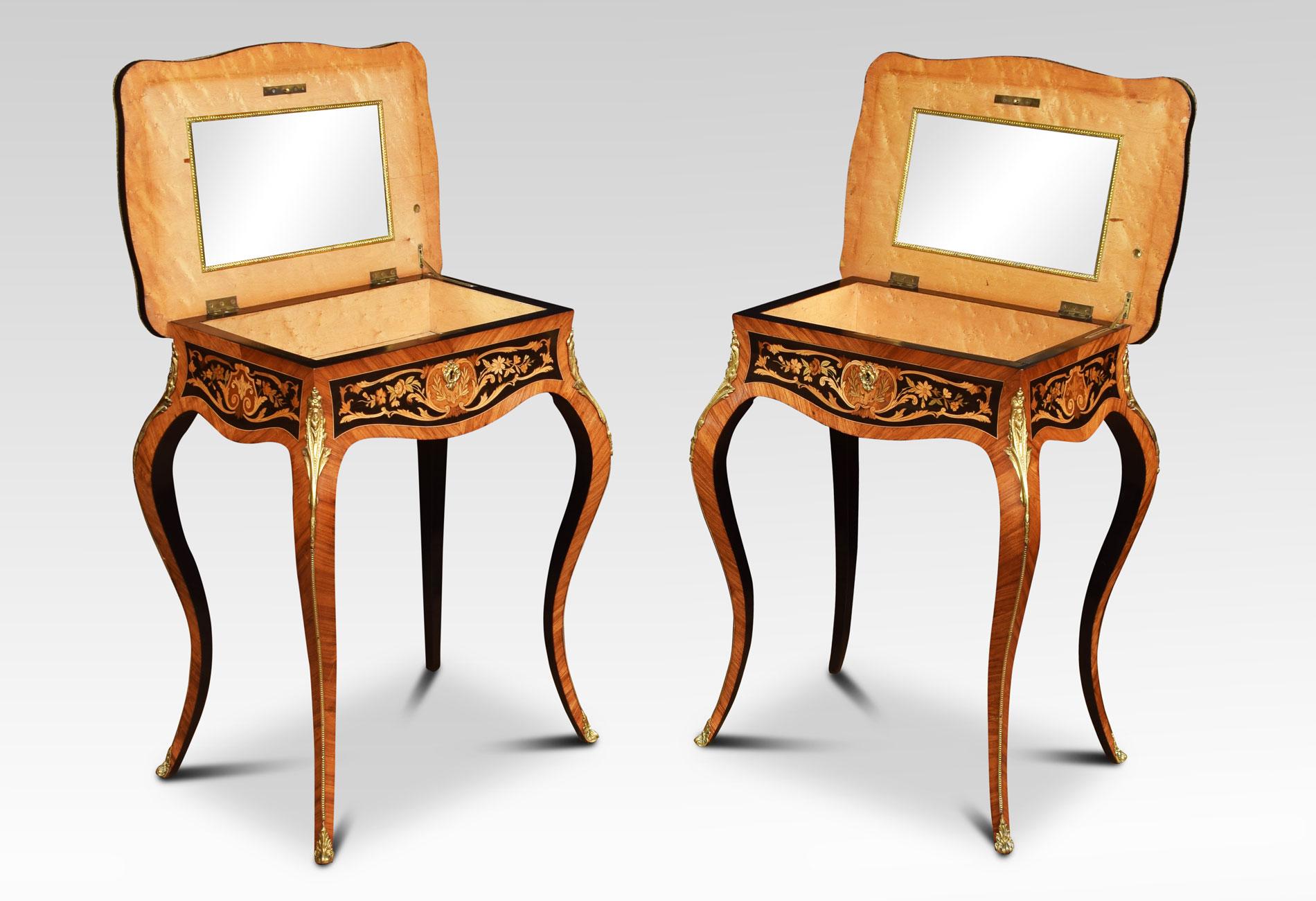 Pair of kingwood side tables the floral marquetry scrolling inlaid tops having brass rim enclosing storage compartment with mirrored lid all raised up on slender cabriole brass-mounted supports.
Dimensions:
Height 29.5 inches
Length 23.5