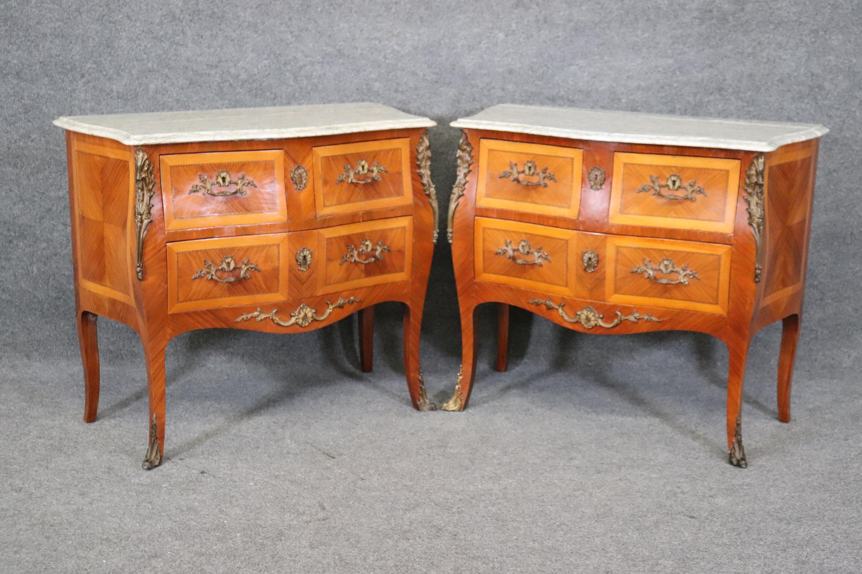 This is a gorgeous pair of satinwood and kingwood marble top commodes with beautifully simple bronze mounts and superb lace marble tops. They are in good condition and hard to find in this two drawer configuration. They won't be around long. They