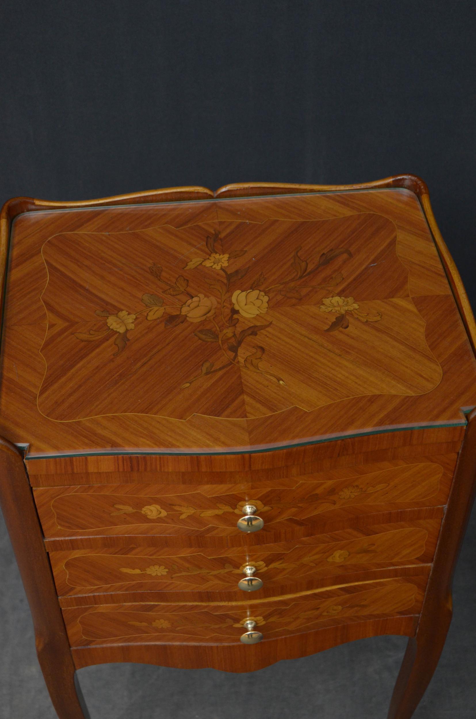 Sn4985 A pair of kingwood bedside cabinets, having shaped gallery to the inlaid top fitted with protective glass above three flower inlaid drawers fitted with original brass handles and inlaid sides, all standing on cabriole legs with brass sabots.