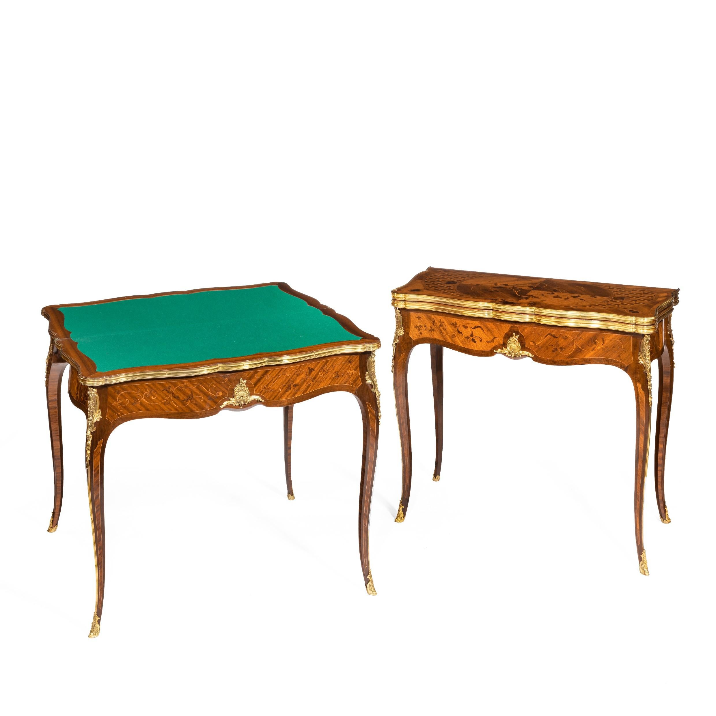 A pair of kingwood card tables by G. Durand, each with a shaped folding top above a serpentine frieze and elegant cabriole legs with gilt bronze foliate mounts, edges and sabots, decorated overall with superb marquetry panels of cross-grained