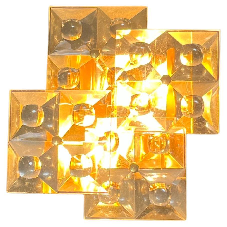 Pair of brass and crystal glass sconces from Kinkeldey, Germany, 1970s, brass frames has patination to it so they are mainly matte finish but can be polished to the original shiny finish they hold four flat crystal cut-glass shape of a flat pyramid