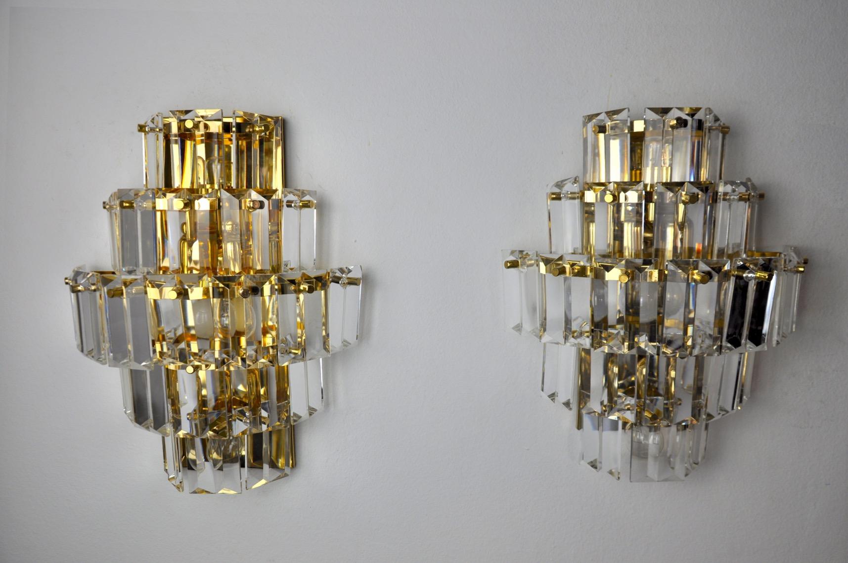 Very nice pair of kinkeldey sconces designed and produced in Germany in the 1970s. Cut crystals spread over four levels of a golden metal structure. Very beautiful design objects that will illuminate your interior wonderfully. Electricity checked,