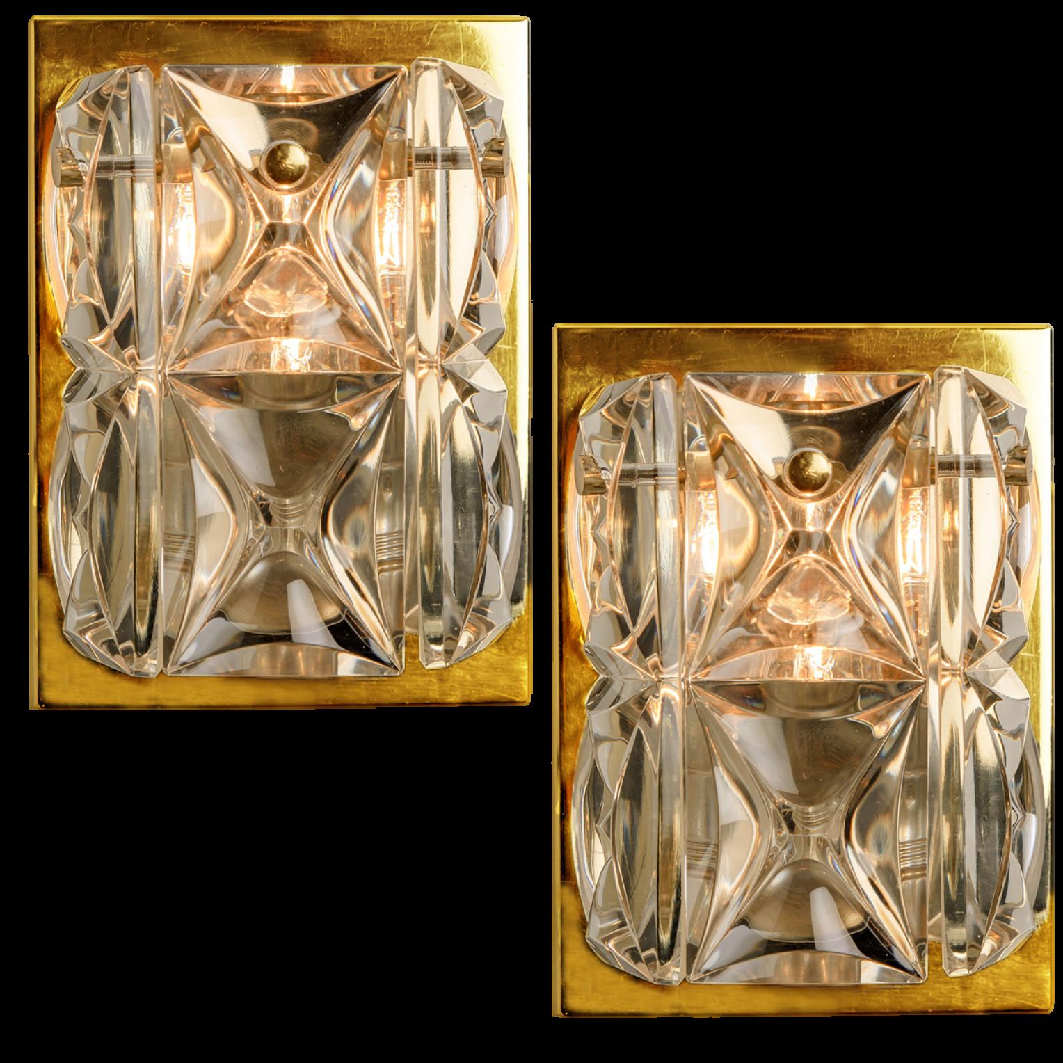 A pair of wall light fixtures by Kinkeldey, Germany, manufactured in the midcentury, circa 1970 (late 1960s or early 1970s). The wall lights are executed to a very high standard. The large square crystals reflect the light beautifully. These