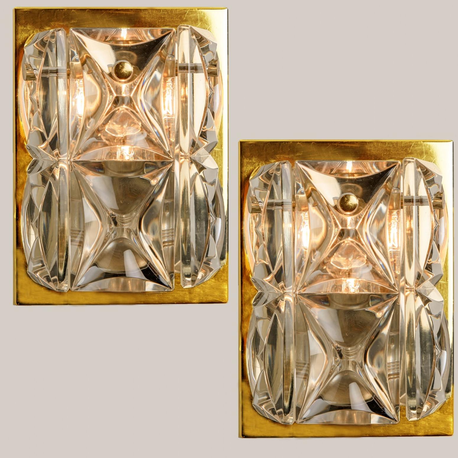 A pair of wall light fixtures by Kinkeldey, Germany, manufactured in the midcentury, circa 1970 (late 1960s or early 1970s). The wall lights are executed to a very high standard. The large square crystals reflect the light beautifully. These