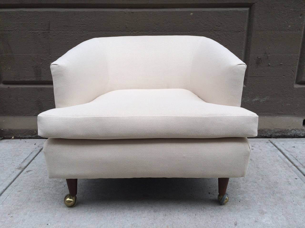 Pair of Kipp Stewart for Directional lounge chairs. Upholstered in linen. Legs are wood with casters.
