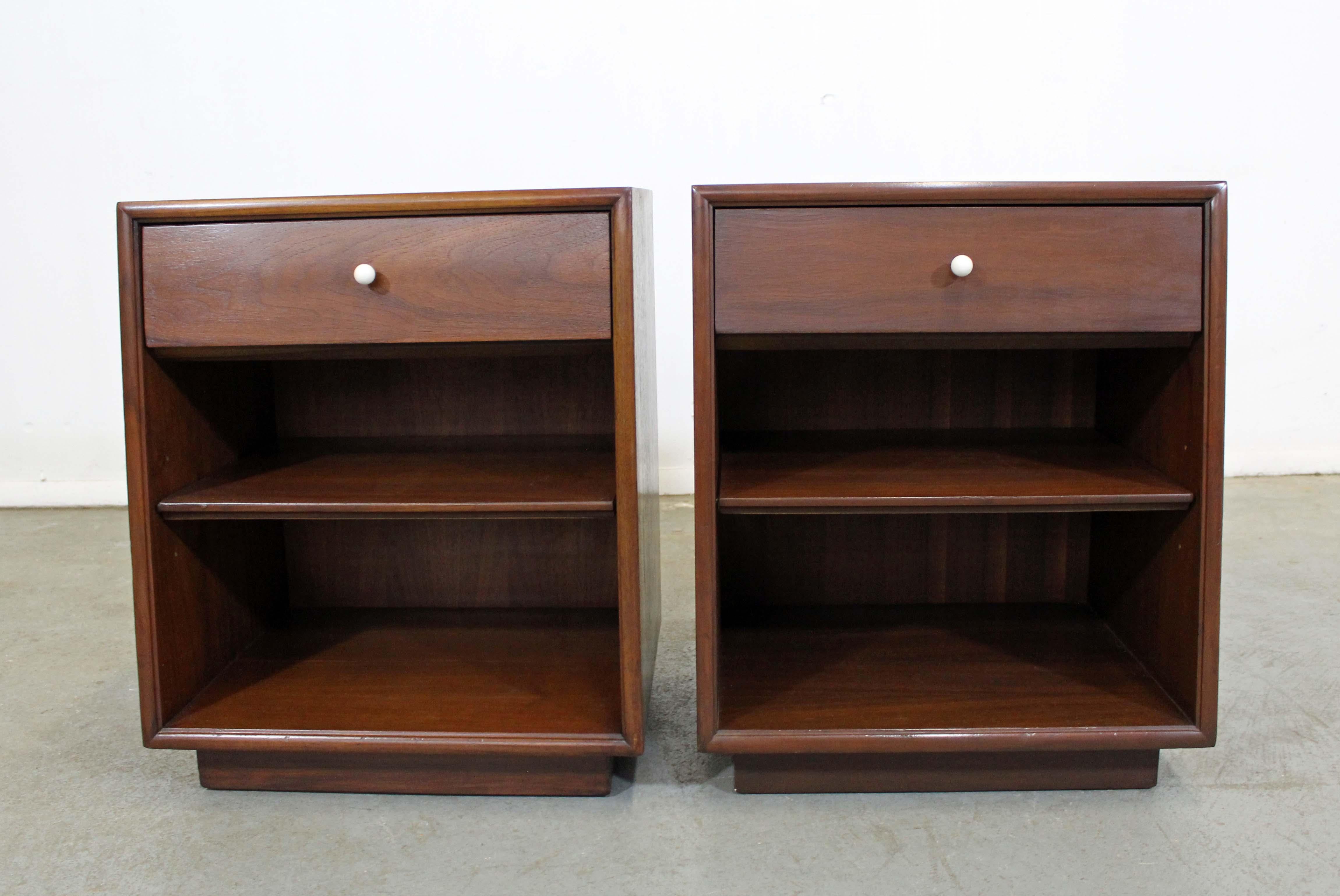 Offered is a pair of walnut nightstands designed by Kipp Stewart for Drexel 
