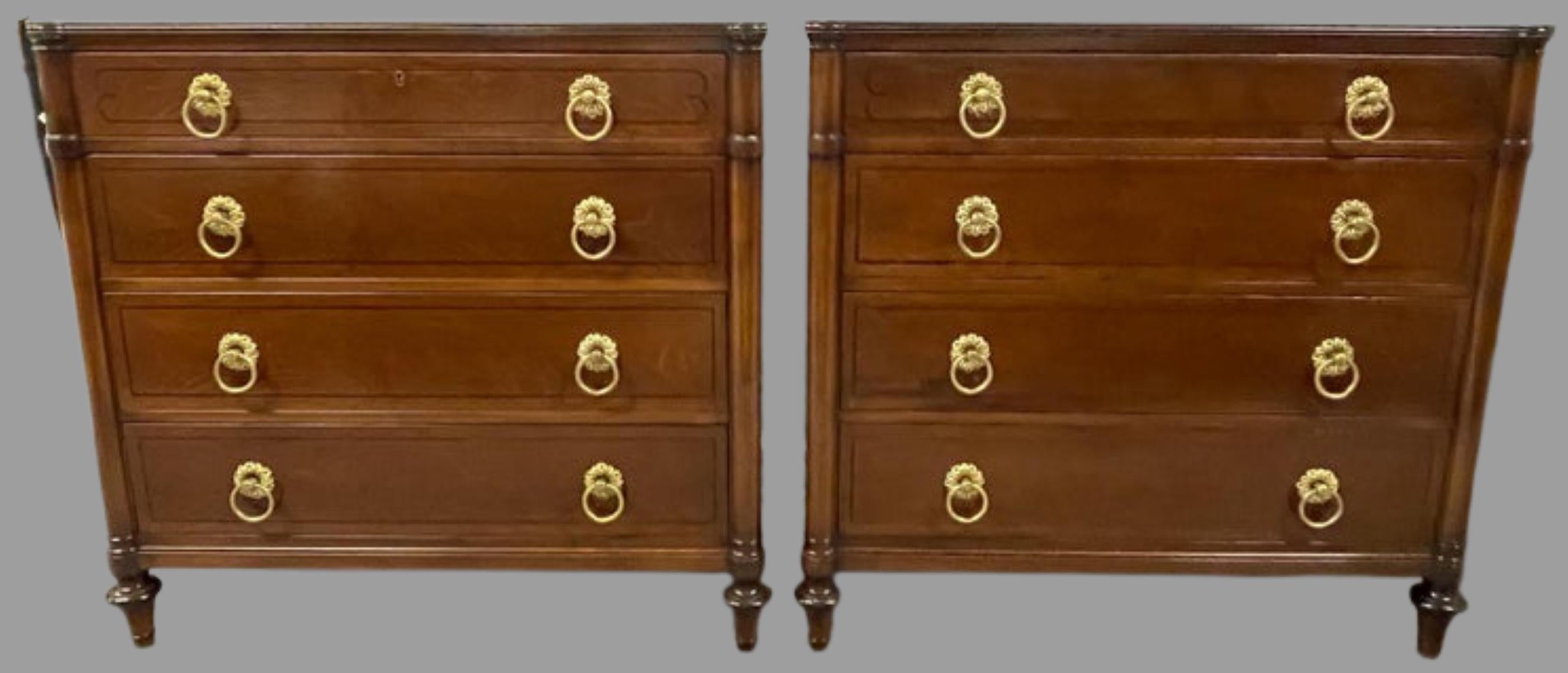 A finely constructed pair of Georgian style custom Kittinger signed chests. The pair having four drawers with bronze pulls. The walnut cases having been meticulously refinished in a walnut with ebony highlights.