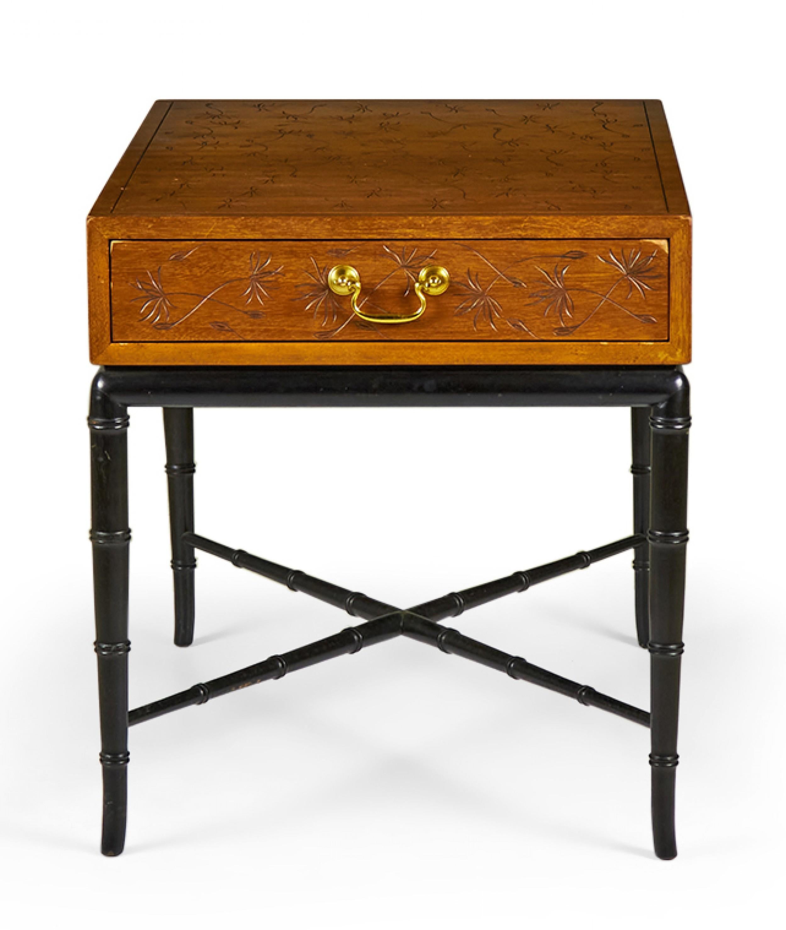PAIR of Hollywood Regency-style (1950s) end / side tables with a walnut top section with an incised dandelion design and a single drawer with a brass drawer pull, resting on a black lacquered faux bamboo base with four tapered legs and an x-shaped