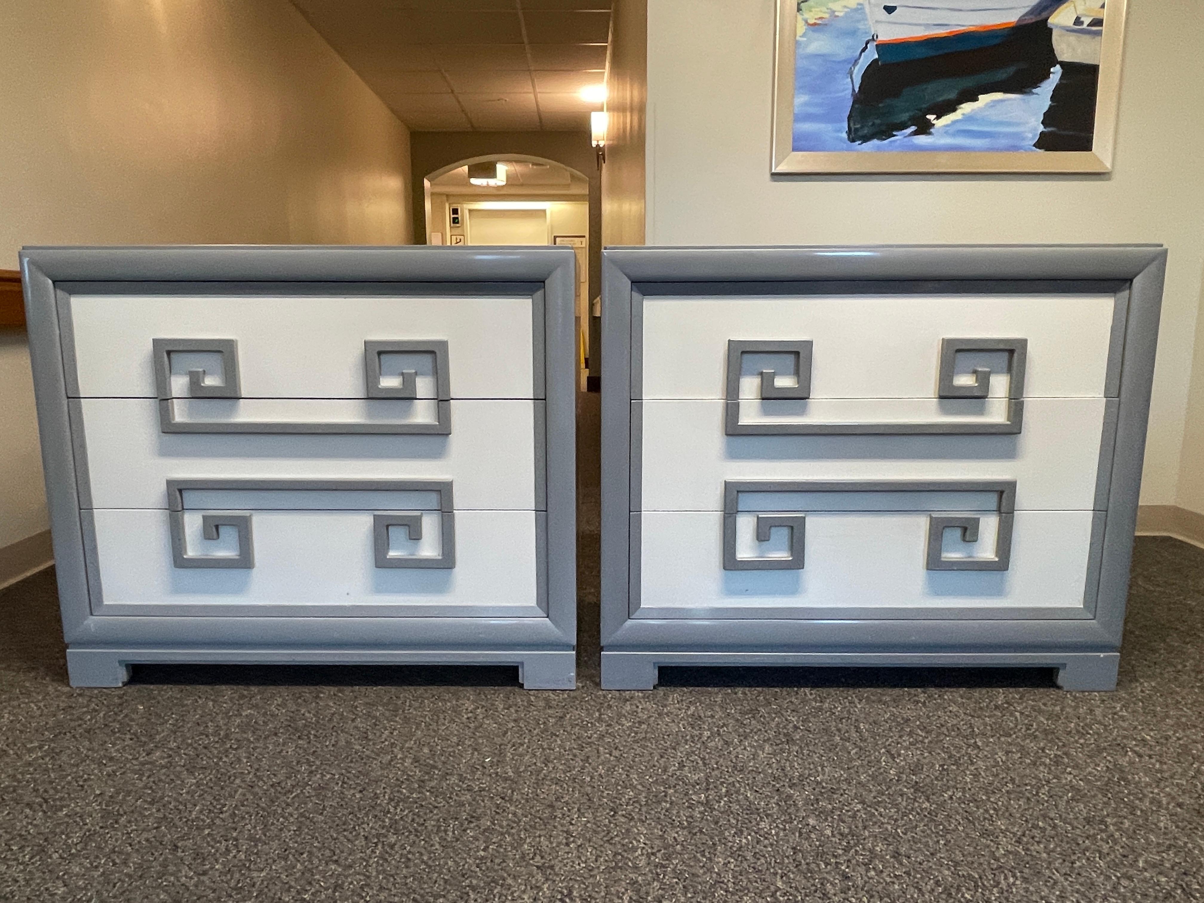 Pair of original three drawer chests by Kittinger of Buffalo from their modernist Mandarin collection, 1947.
Boldly contrasting Greek key design integrated into drawer pulls.
Glass tops, deep divided drawers with vide poche sliding tray.
Putty grey