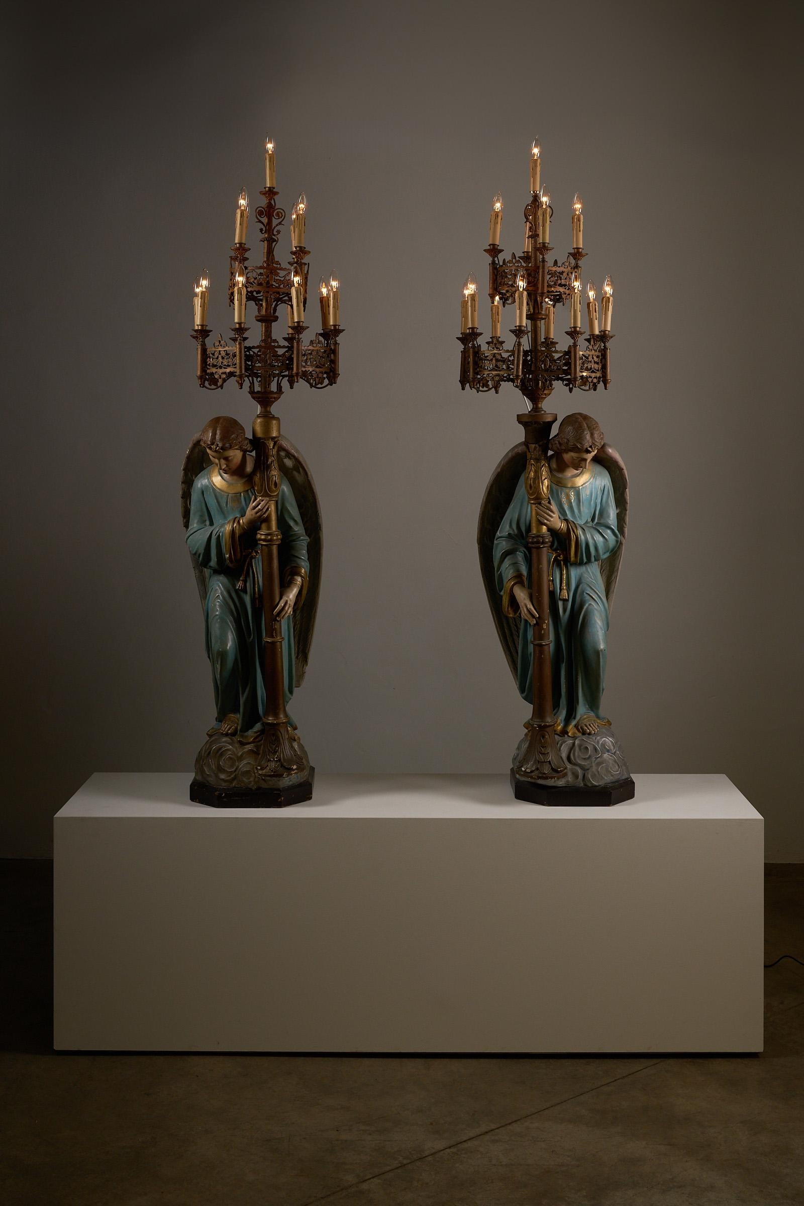 This exceptional pair of kneeling angel candle holders, crafted in the 19th century, are truly rare and unique pieces. Sourcing such highly detailed religious sculptures is incredibly difficult, making these pieces a treasure for collectors and