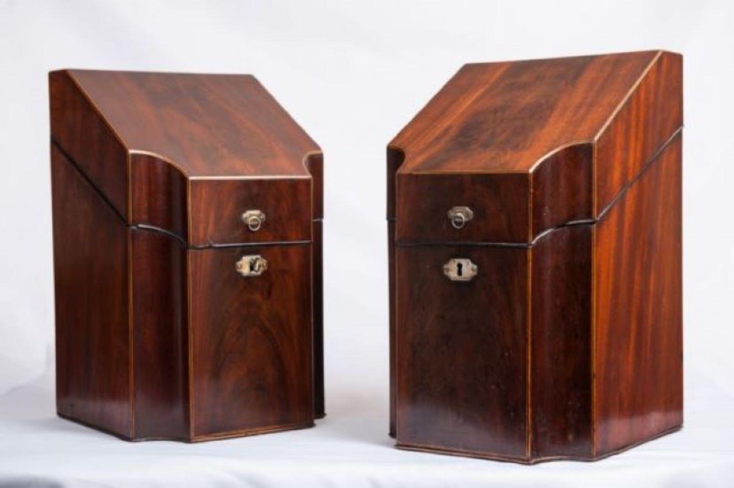 Pair of 18th century Georgian, mahogany knife boxes or cutlery cases. The interiors fitted with original compartments to hold knives forks and spoons,. Inlaid with boxwood stringing. The exteriors in a lovely richly grained mahogany bordered with