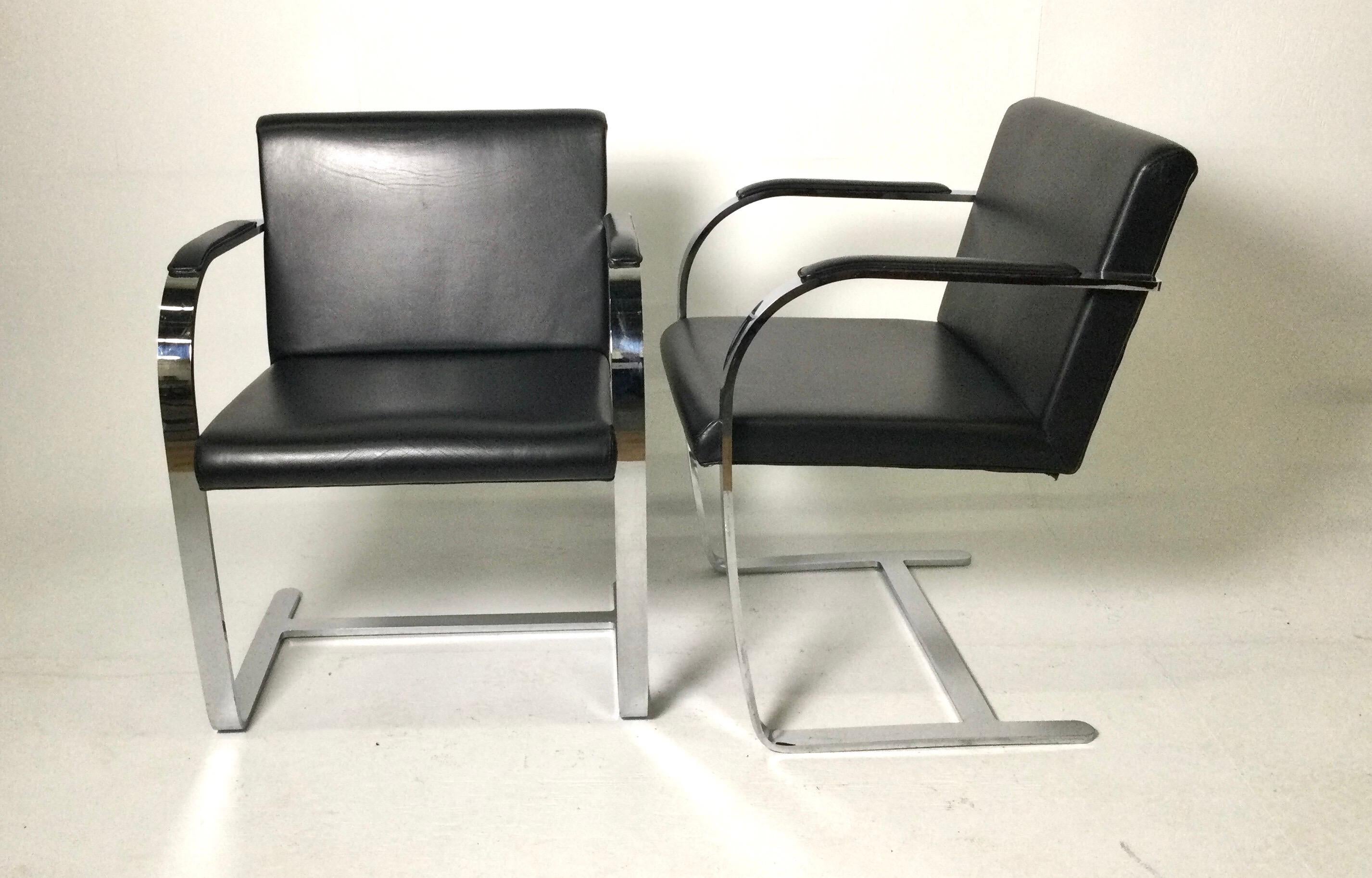 Pair of Knoll Bruno style flat bar chairs with black leather upholstery. Bought in the D & D building in NYC in the early 1980's. No Knoll markings but heavy. Very comfy. Very minor age appropriate wear from use.