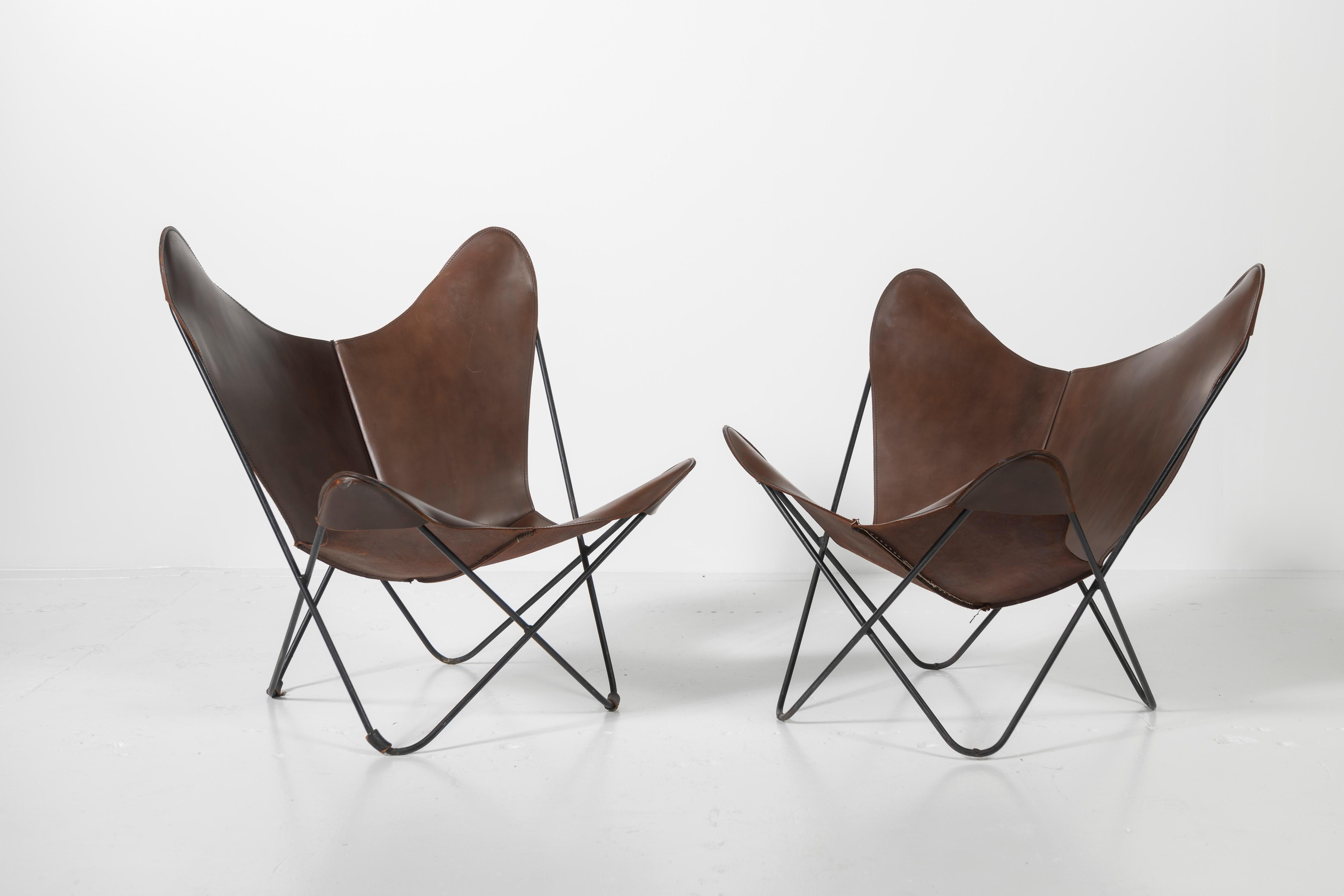 Iconic Knoll butterfly chairs, sold individually or as a pair, suitable for interior or exterior use. Gently worn leather slings add to the character of these pieces, sure to be enjoyed in every setting.