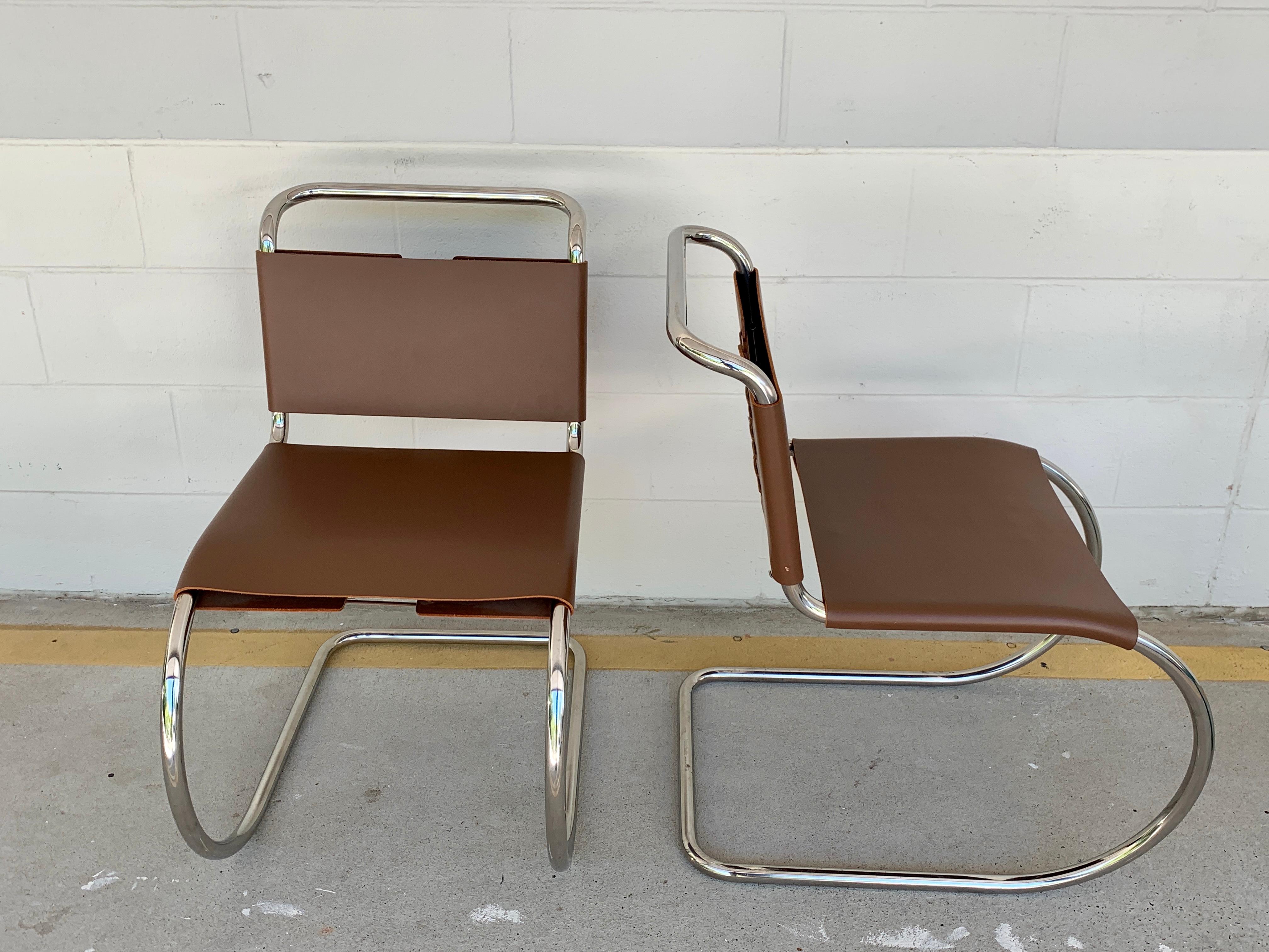 Pair of Knoll MR chair, Stamped Knoll & Mies van der Rohe, light brown cowhide
materials tubular stainless steel and thick light brown leather sling seat with leather laces.
 