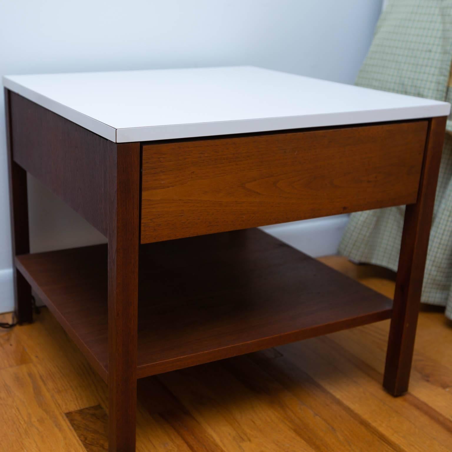 Early 1960s pair of walnut single drawer nightstands or end tables with white laminate tops.